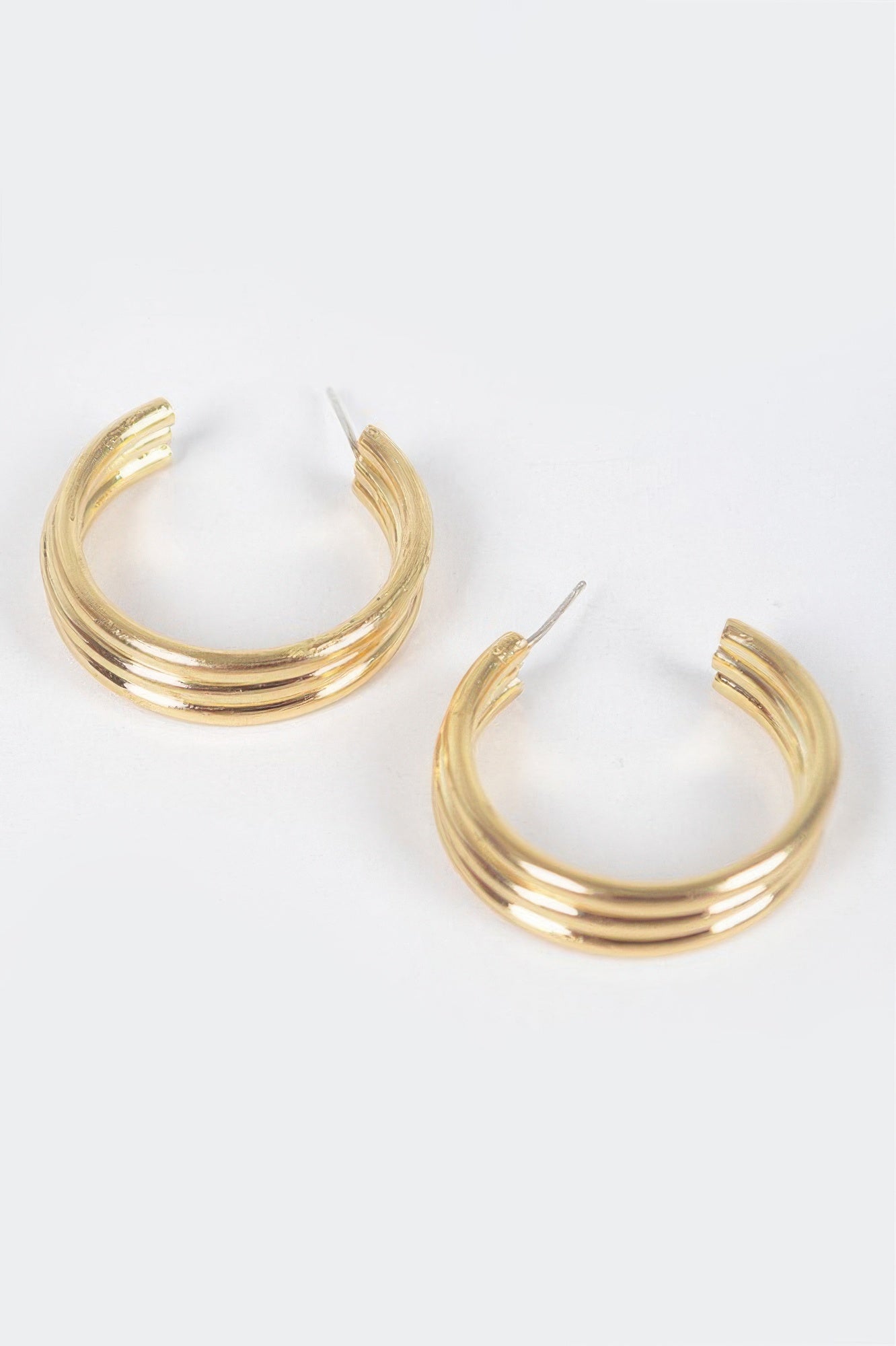 Triple hoop earrings, gold-tone stacked rings on hook posts