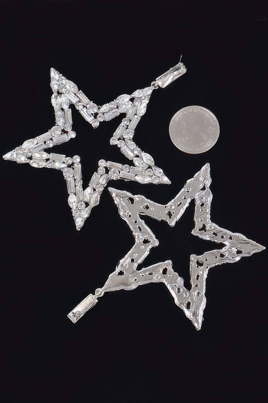 Silver star dangle earrings with openwork star frame and rhinestone accents