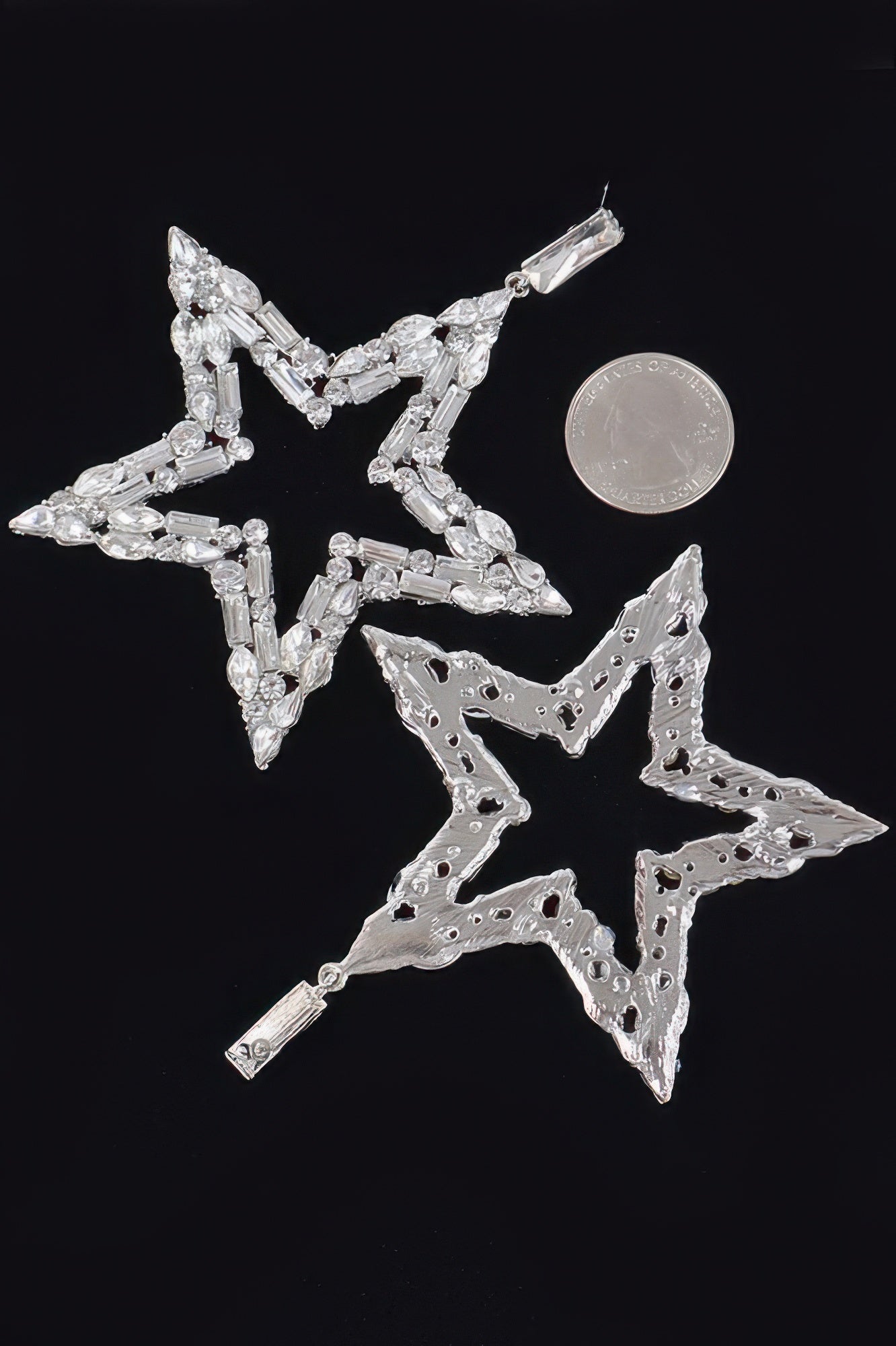 Silver star dangle earrings with openwork star frame and rhinestone accents