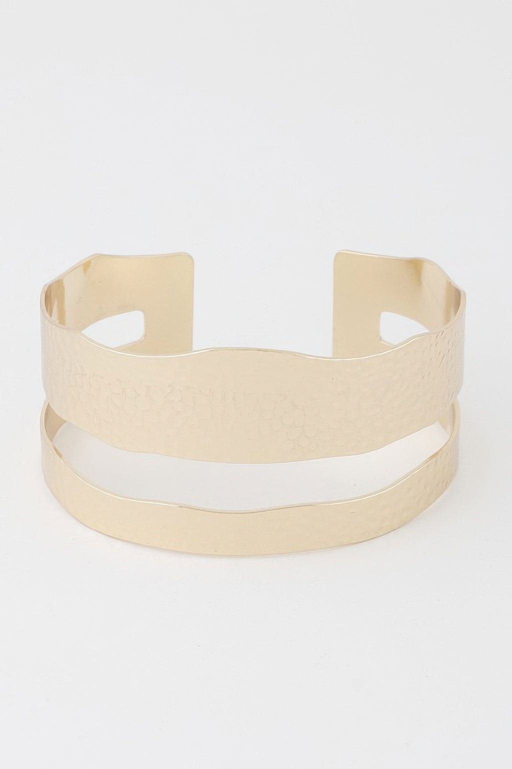 Gold open cuff bracelet with two vertical cutouts and wide hammered texture band.