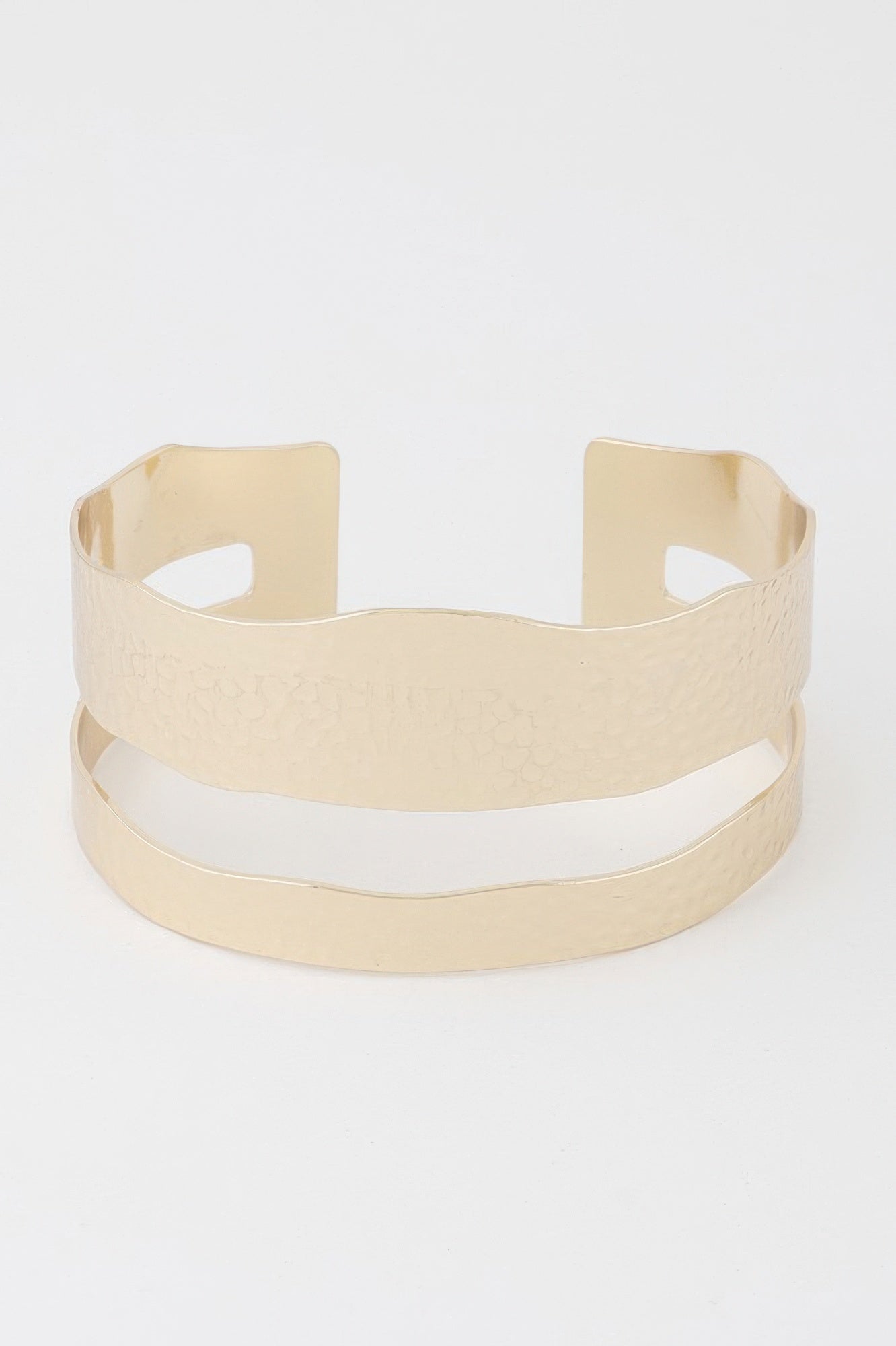 Gold open cuff bracelet with two vertical cutouts and wide hammered texture band.