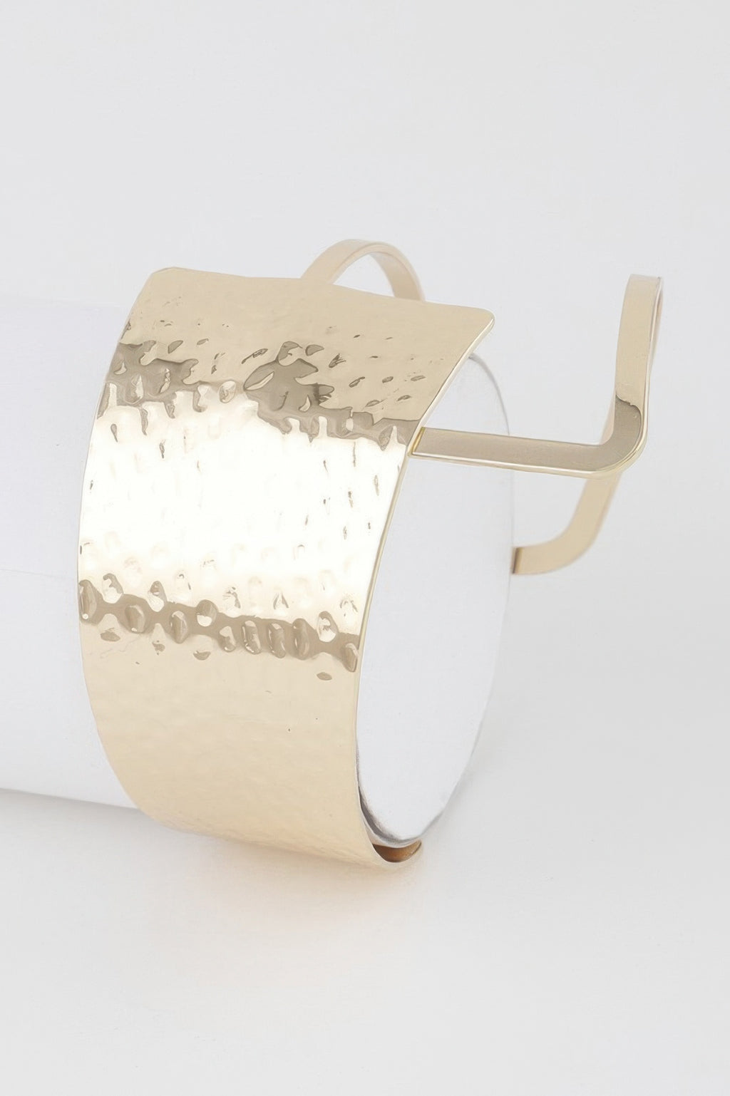 Modern negative space cuff bracelet in gold with perforated cutout pattern
