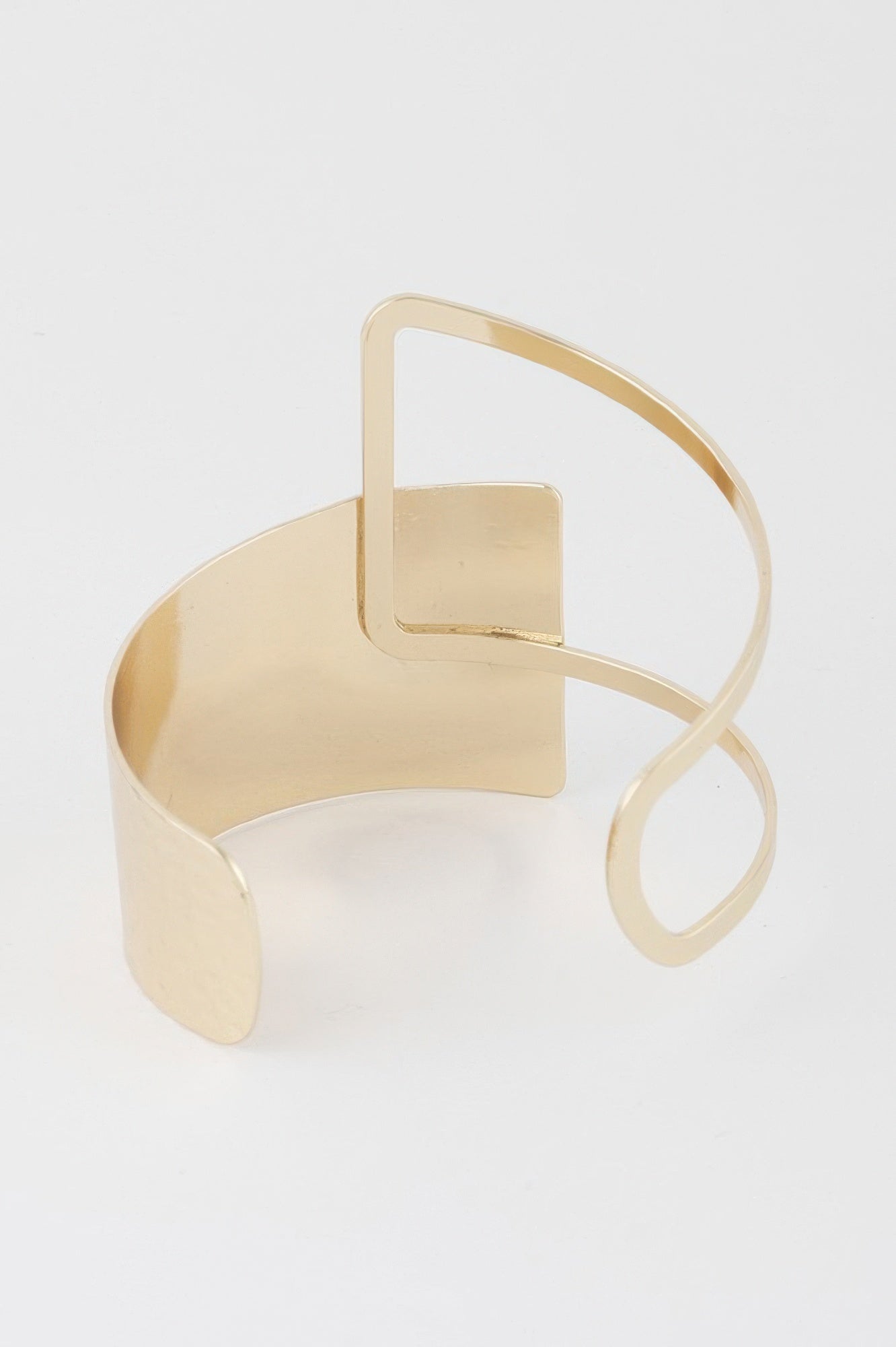 Gold cuff bracelet with wide band and square cutout detail