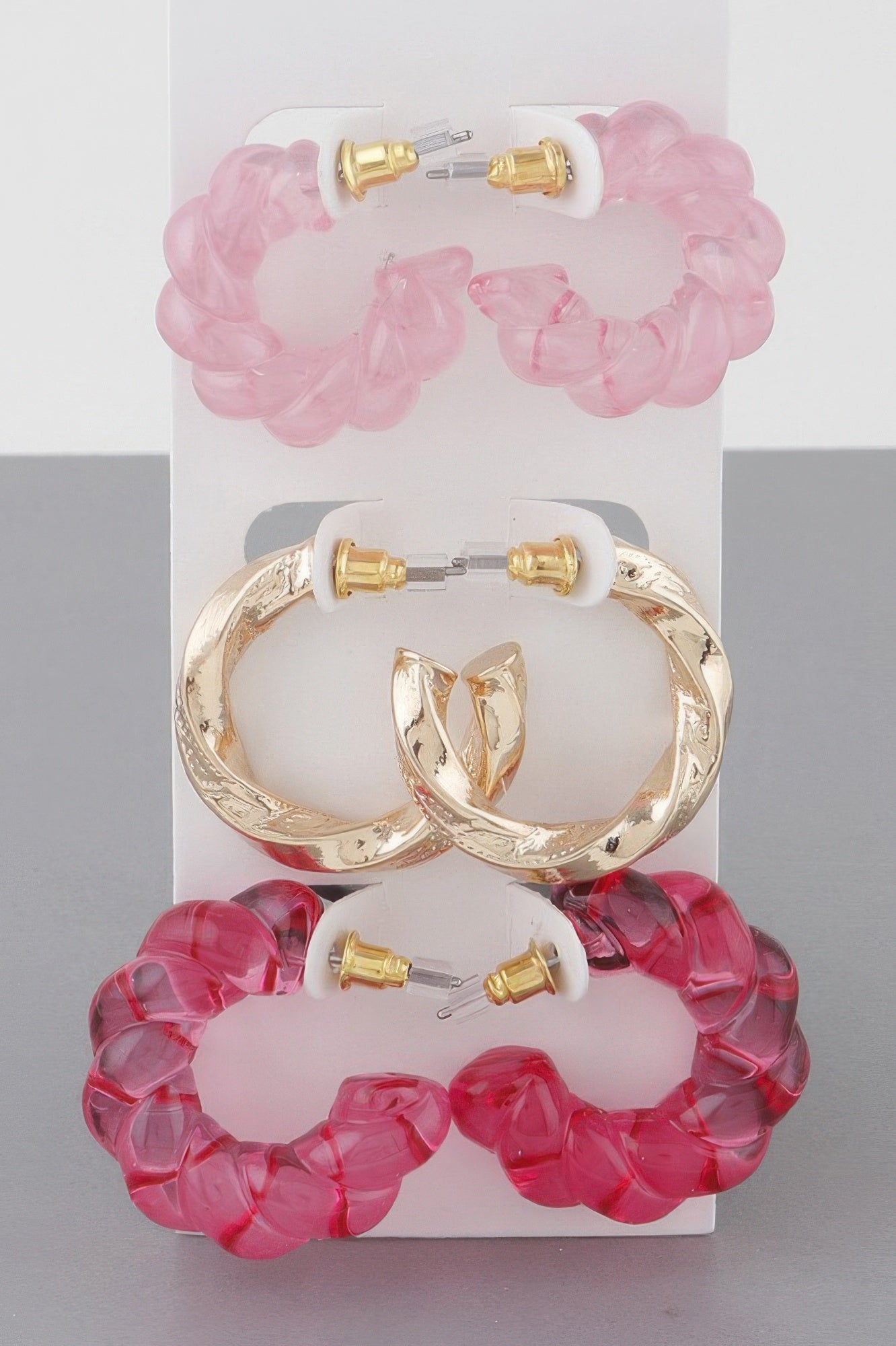 Multi twisted hoop earrings set with pink translucent hoops and gold-tone hoops