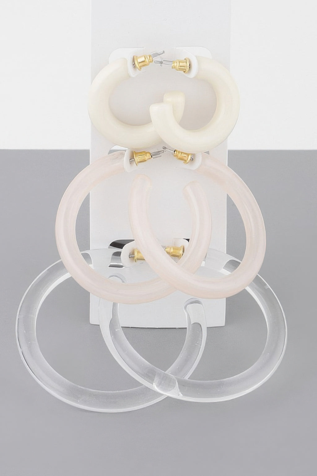 Cream/white multi hoop earrings set with gold-tone posts, large and small rings
