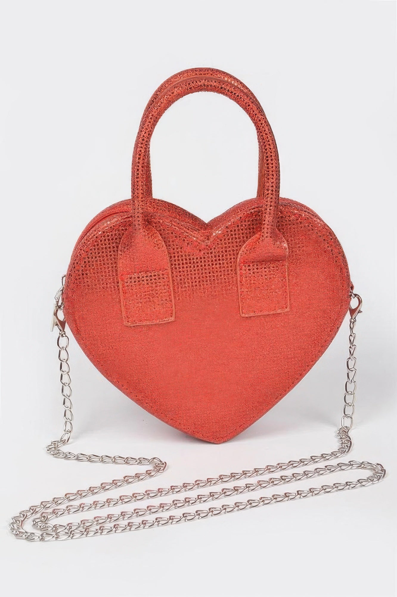 Red metallic heart crossbody bag with top handles and silver chain strap