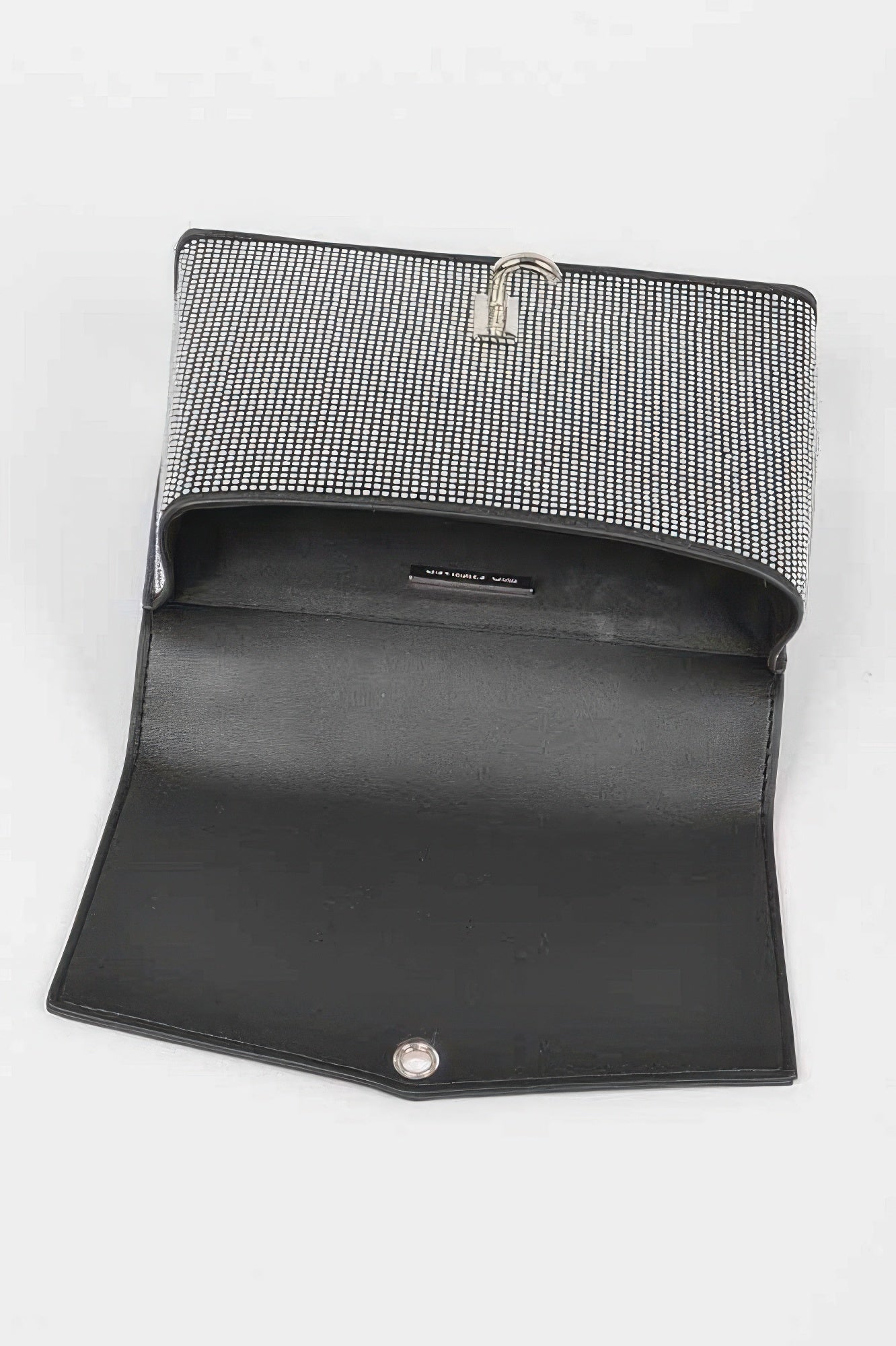Rhinestone clutch opened to show dark interior lining and turn-lock clasp on flap.