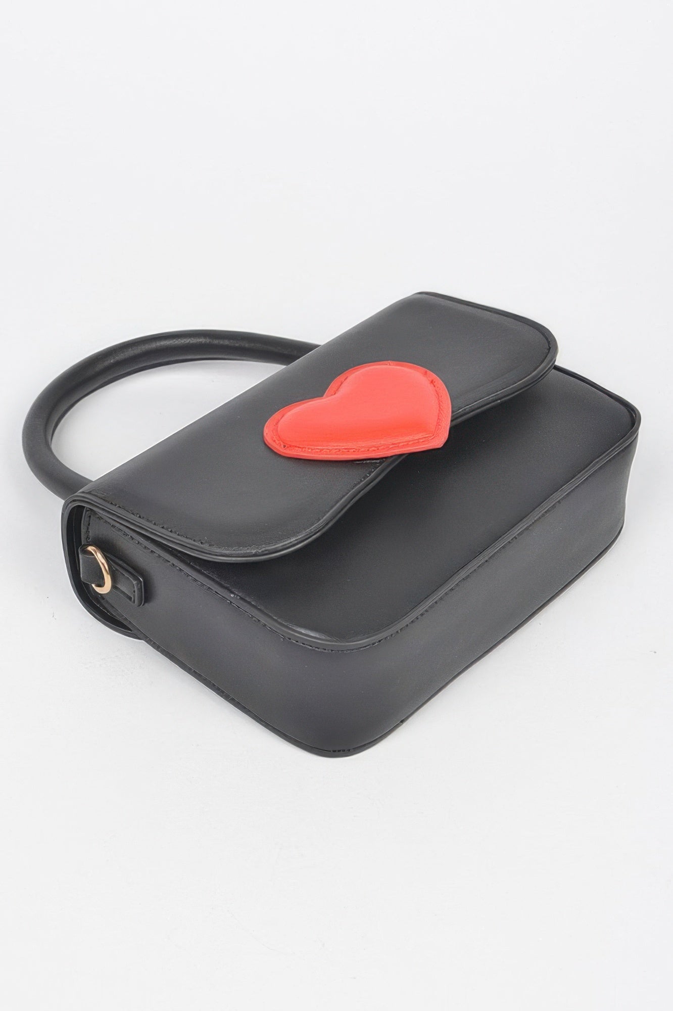 Black vegan bag with red heart flap and curved top handle