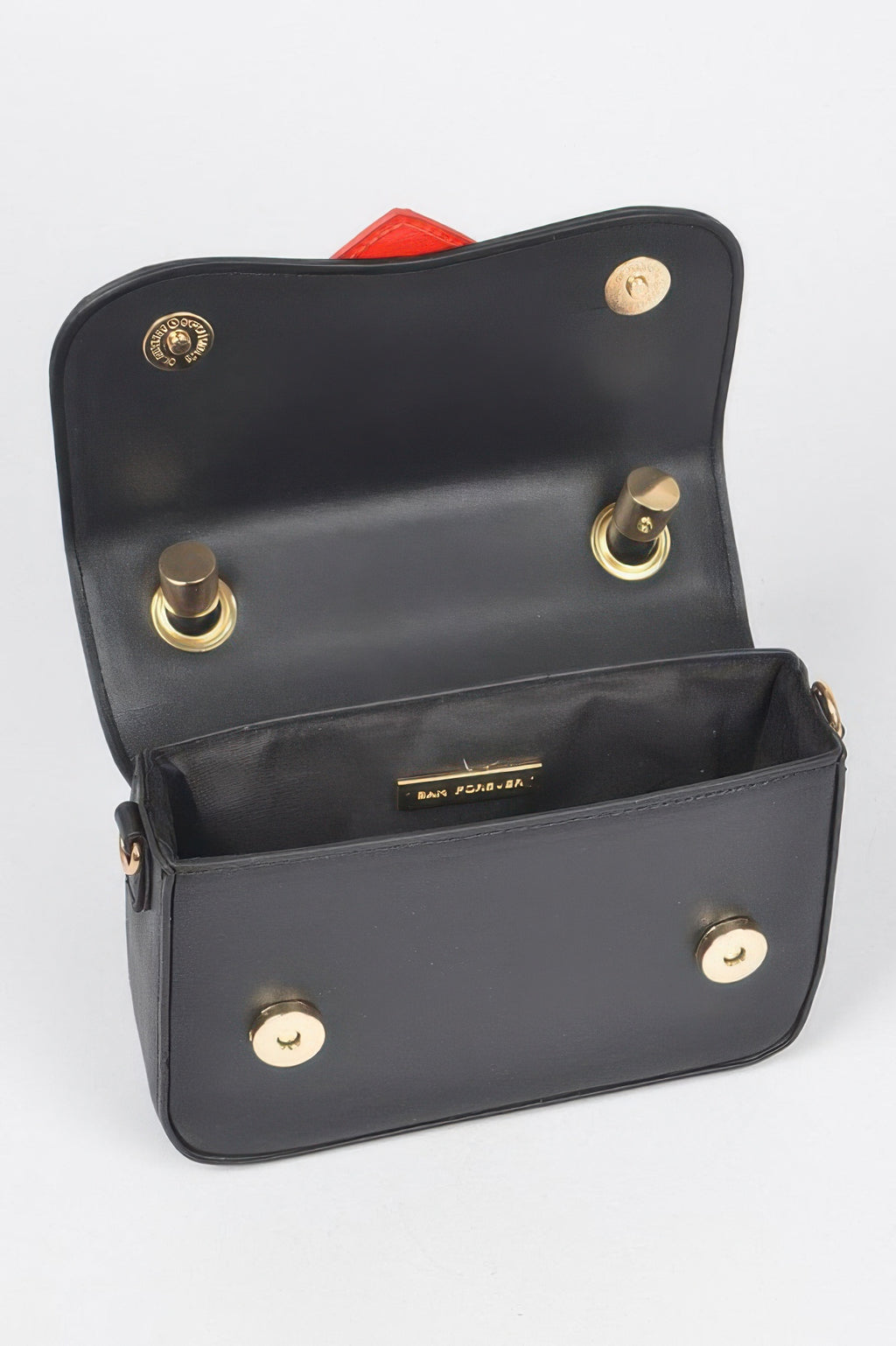 Open black vegan bag with gold snaps and red inner heart lining