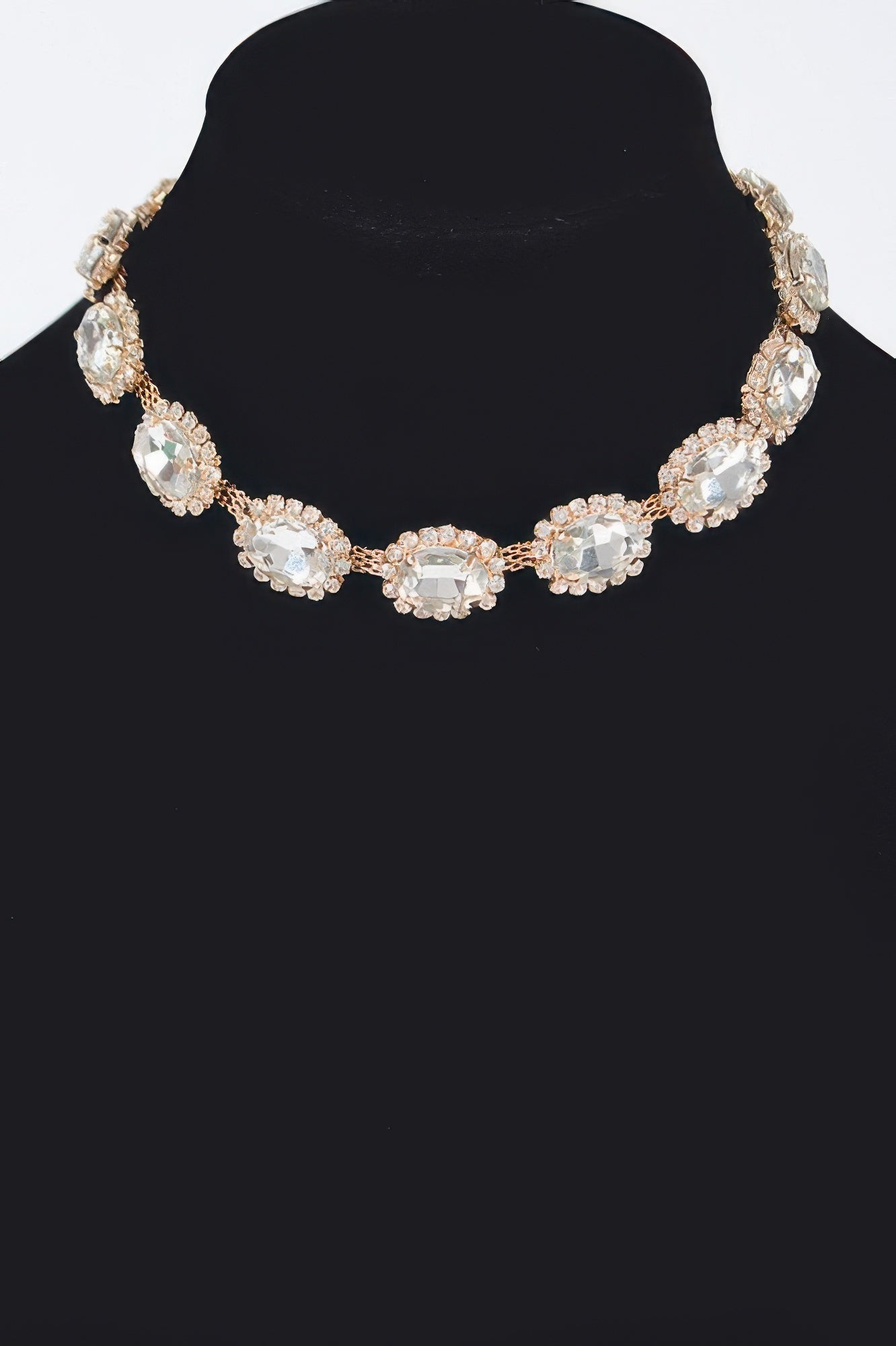 Rhinestone oval necklace with clear stones and gold-tone bezel settings, full front view.