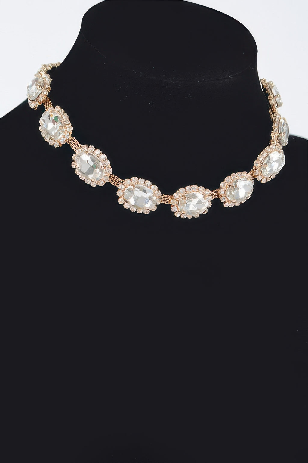 Rhinestone oval necklace with clear stones and silvertone settings, centered on neckline.