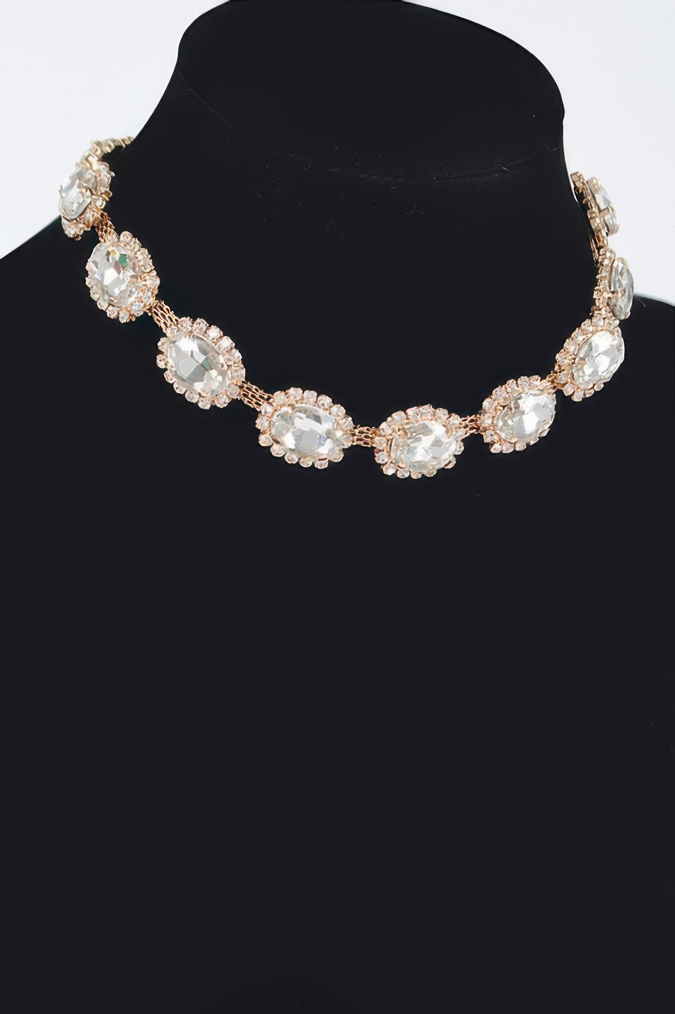 Rhinestone oval necklace with clear stones and silvertone settings, centered on neckline.
