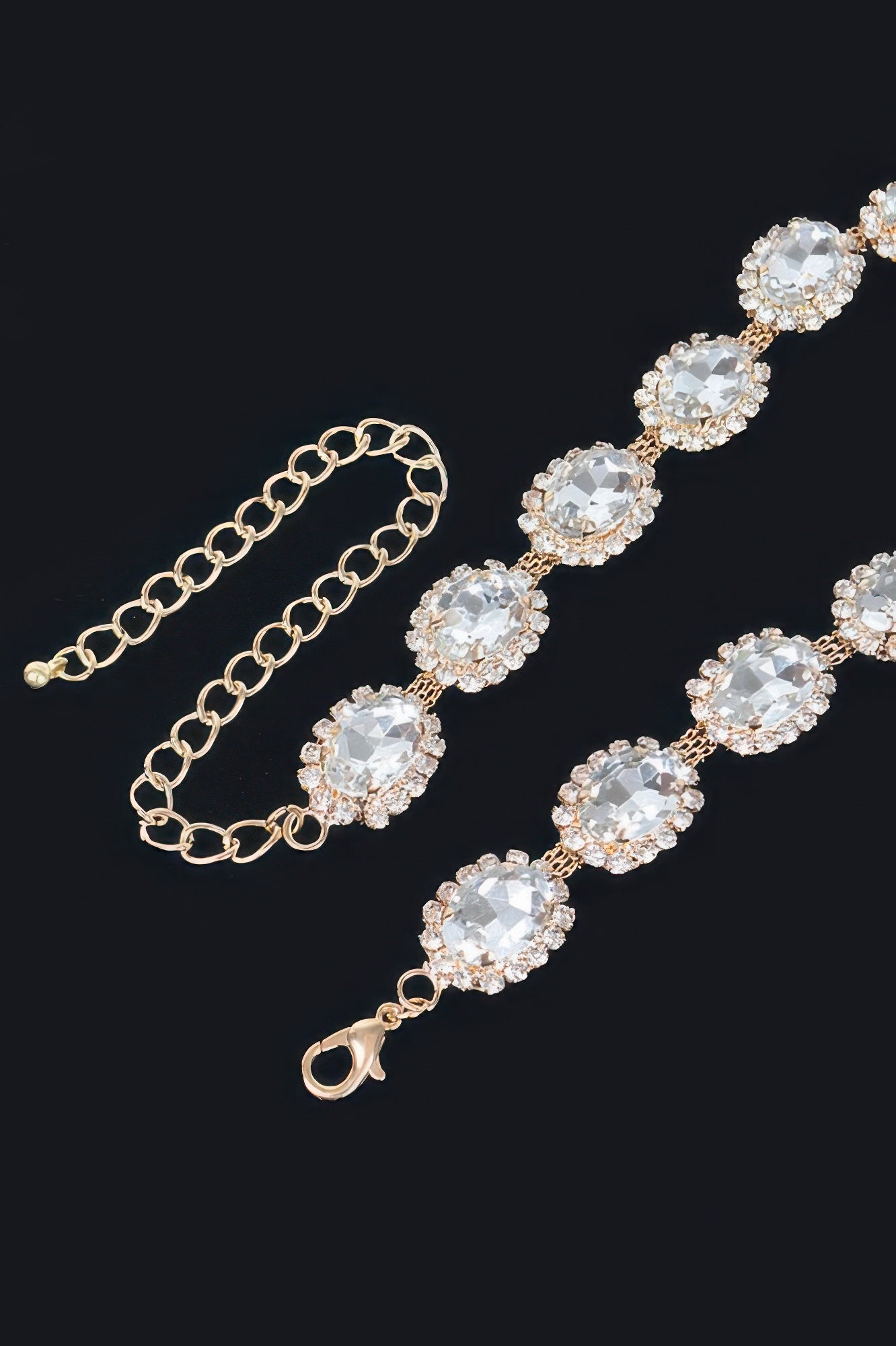 Rhinestone oval necklace detail: gold-tone chain with oval clear stones and lobster clasp.