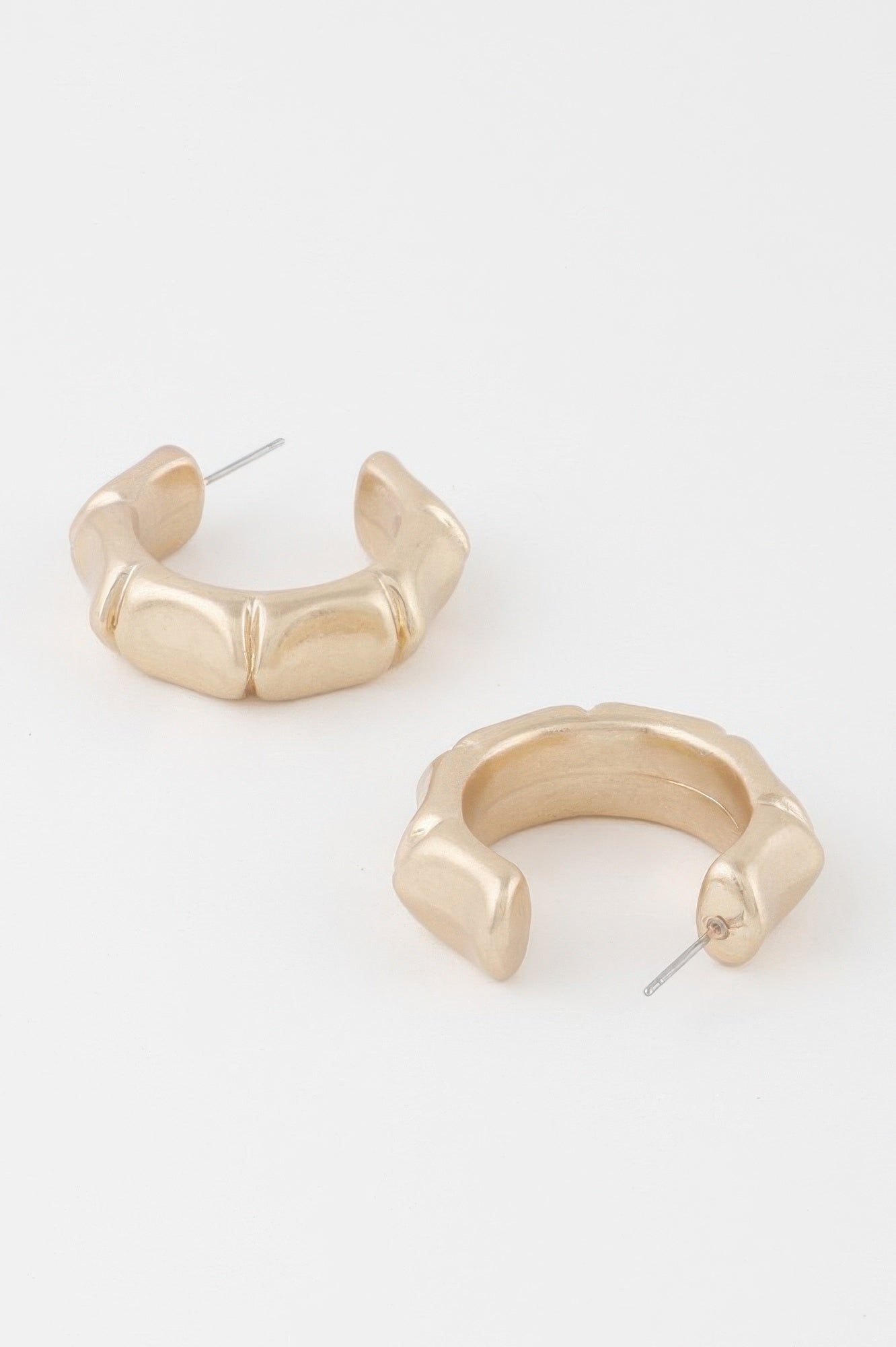Gold skeleton hoop earrings with curved outer links and stud posts