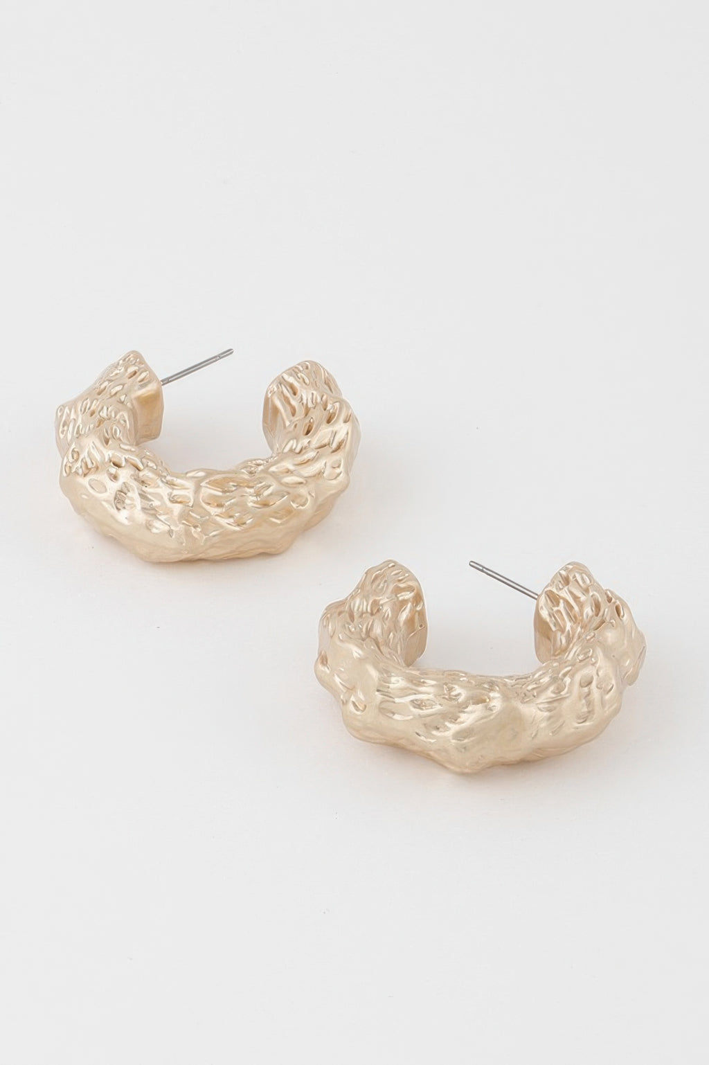 Abstract erosion hoop earrings, gold tone, front view with stud post