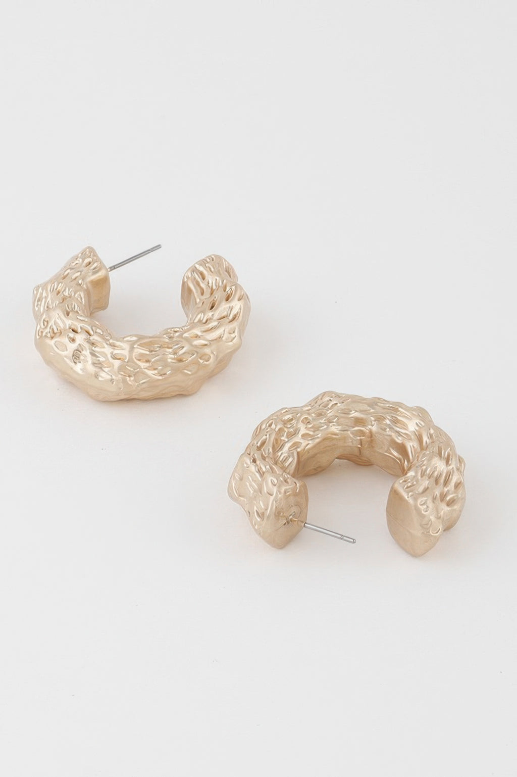 Abstract erosion hoop earrings, gold tone, side view with stud post