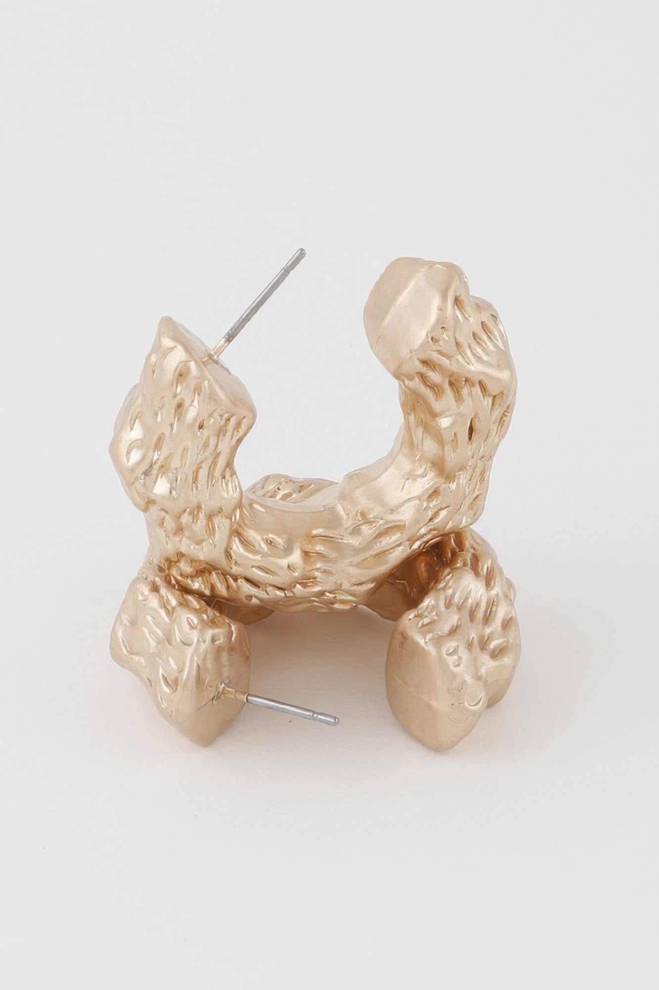 Abstract erosion hoop earrings, gold tone, front close-up with stud post