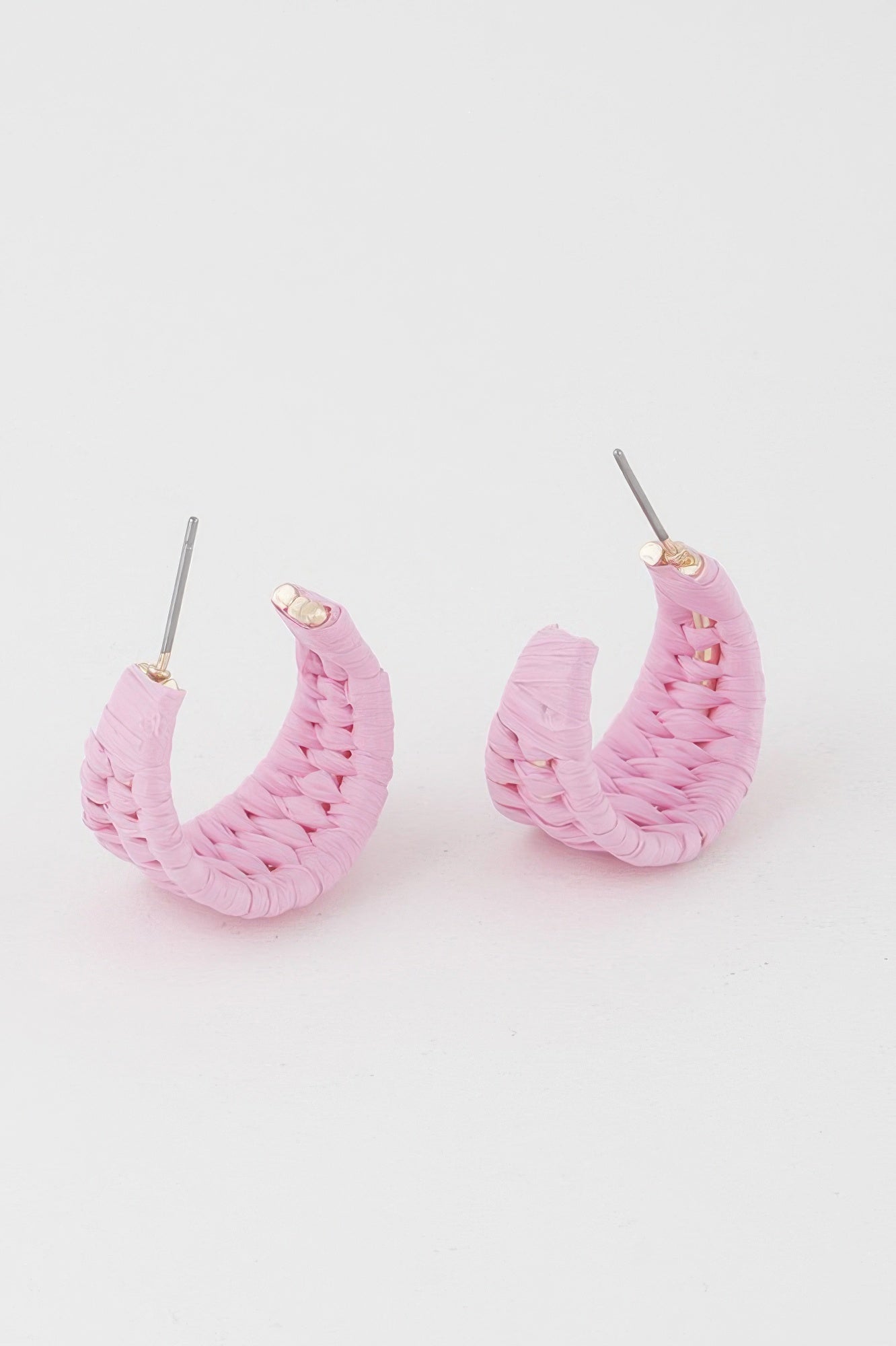 Pink triple-woven hoop earrings with gold-toned studs and slender metal posts