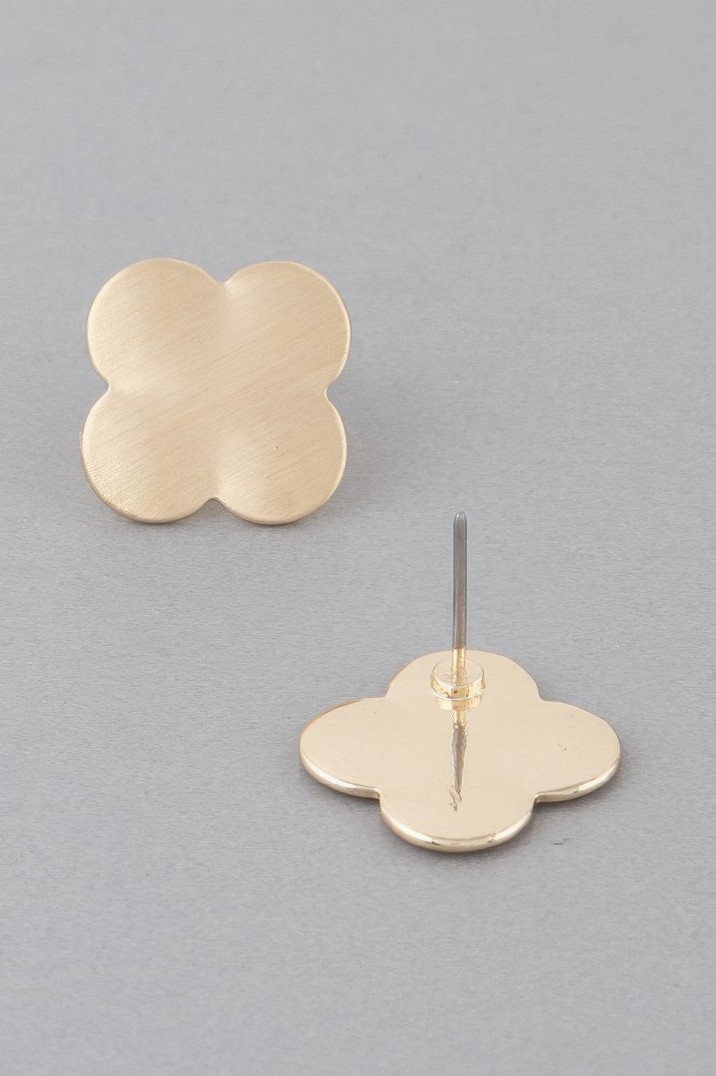 Gold clover stud earrings with visible post and four-lobed clover front