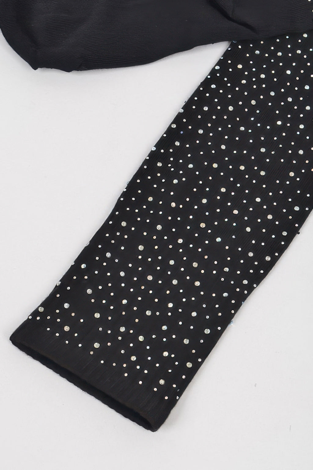Close-up: black stone knee-high sock with scattered silver sparkle dots