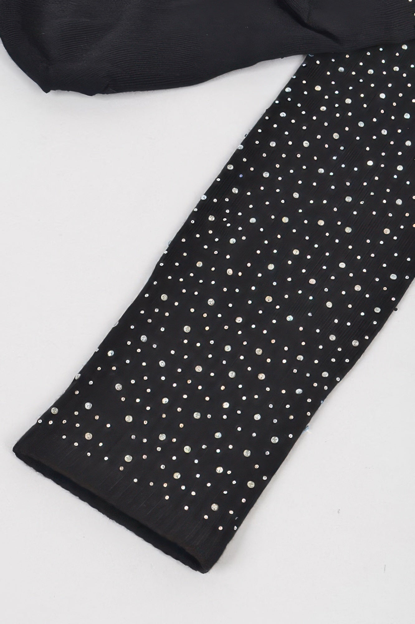 Close-up: black stone knee-high sock with scattered silver sparkle dots