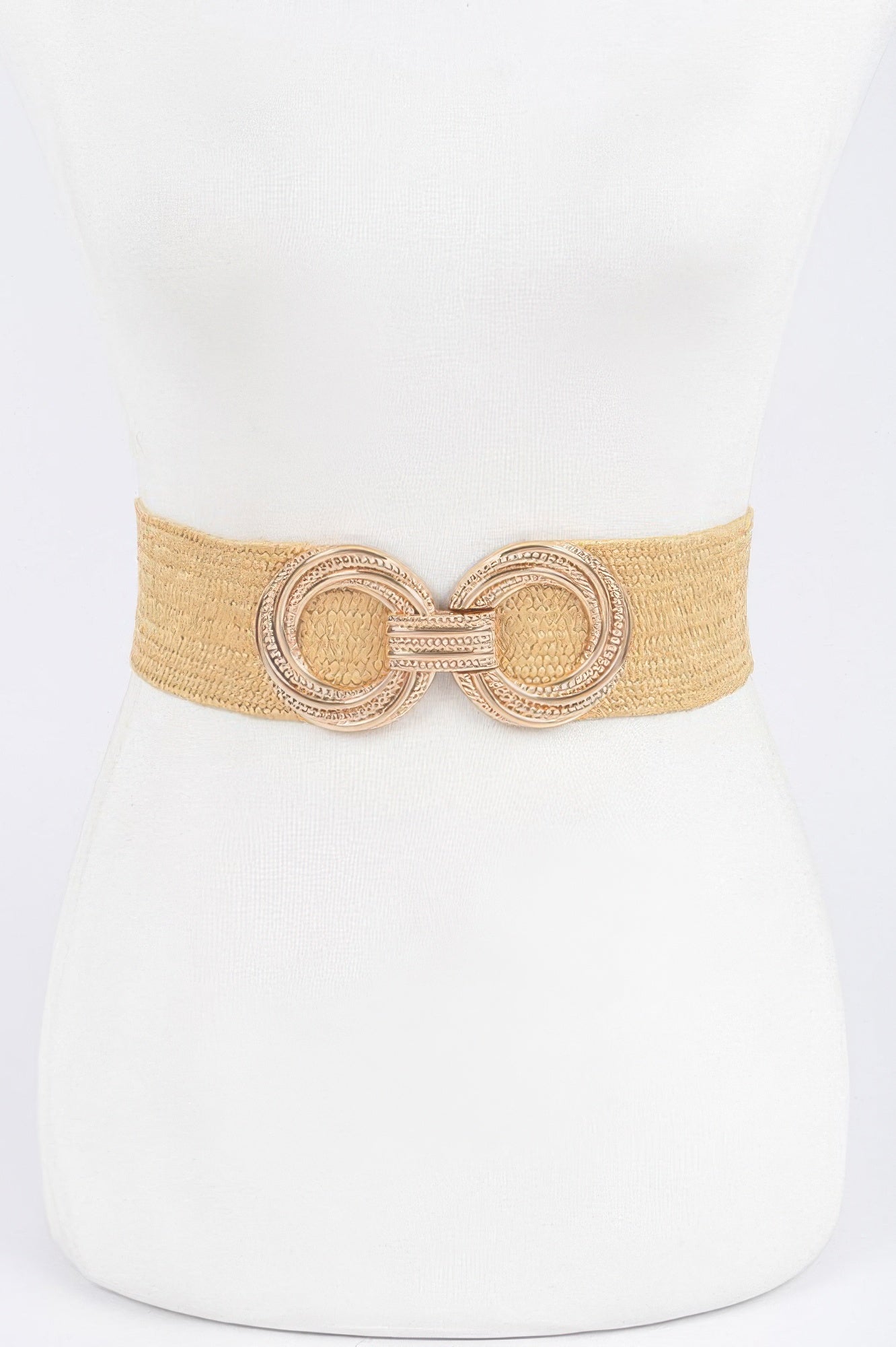 Khaki stretch waist belt with ornate round metal buckle and textured center panels