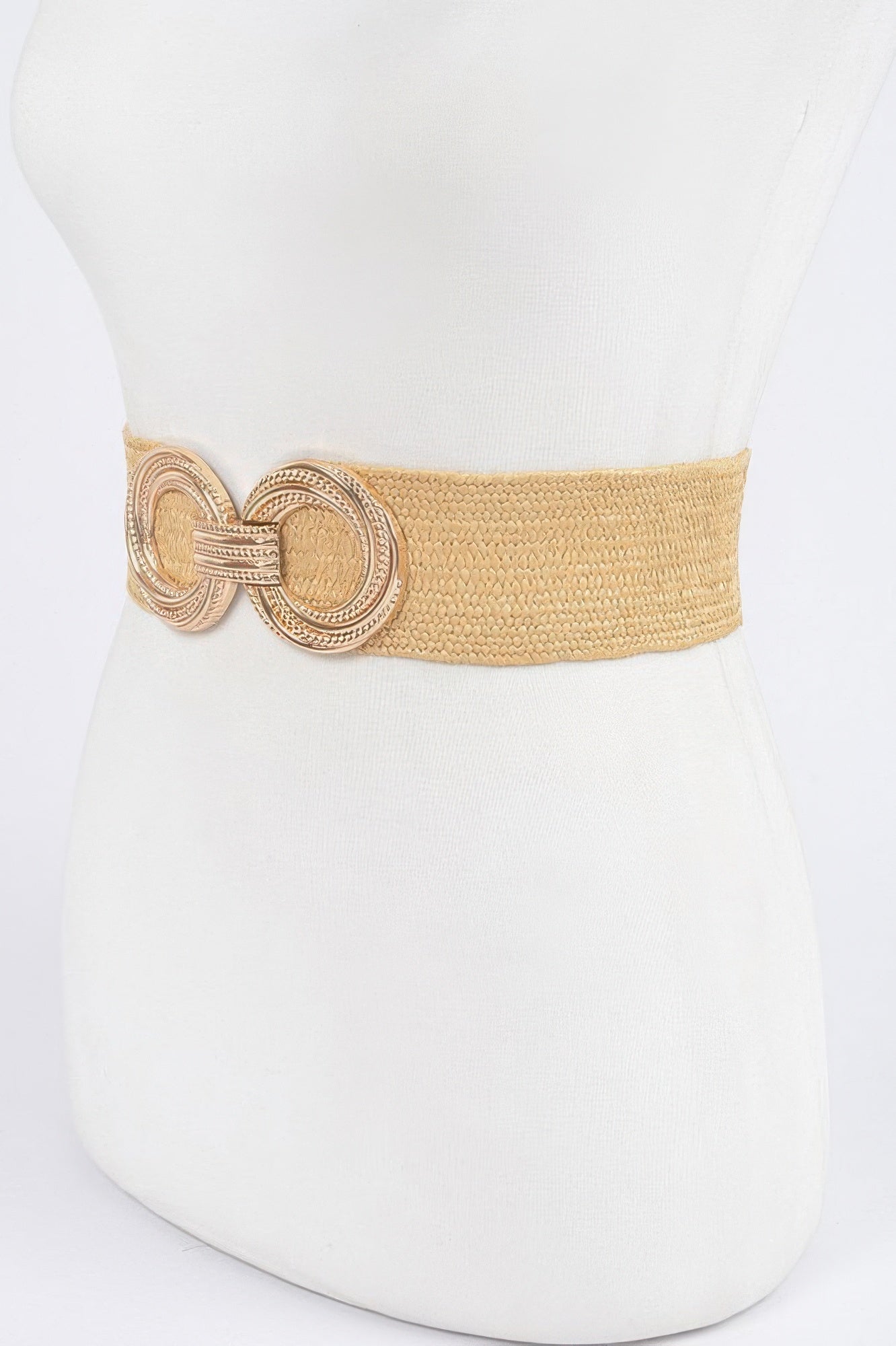 Khaki stretch waist belt, round linked metal buckle with filigree detailing on the strap