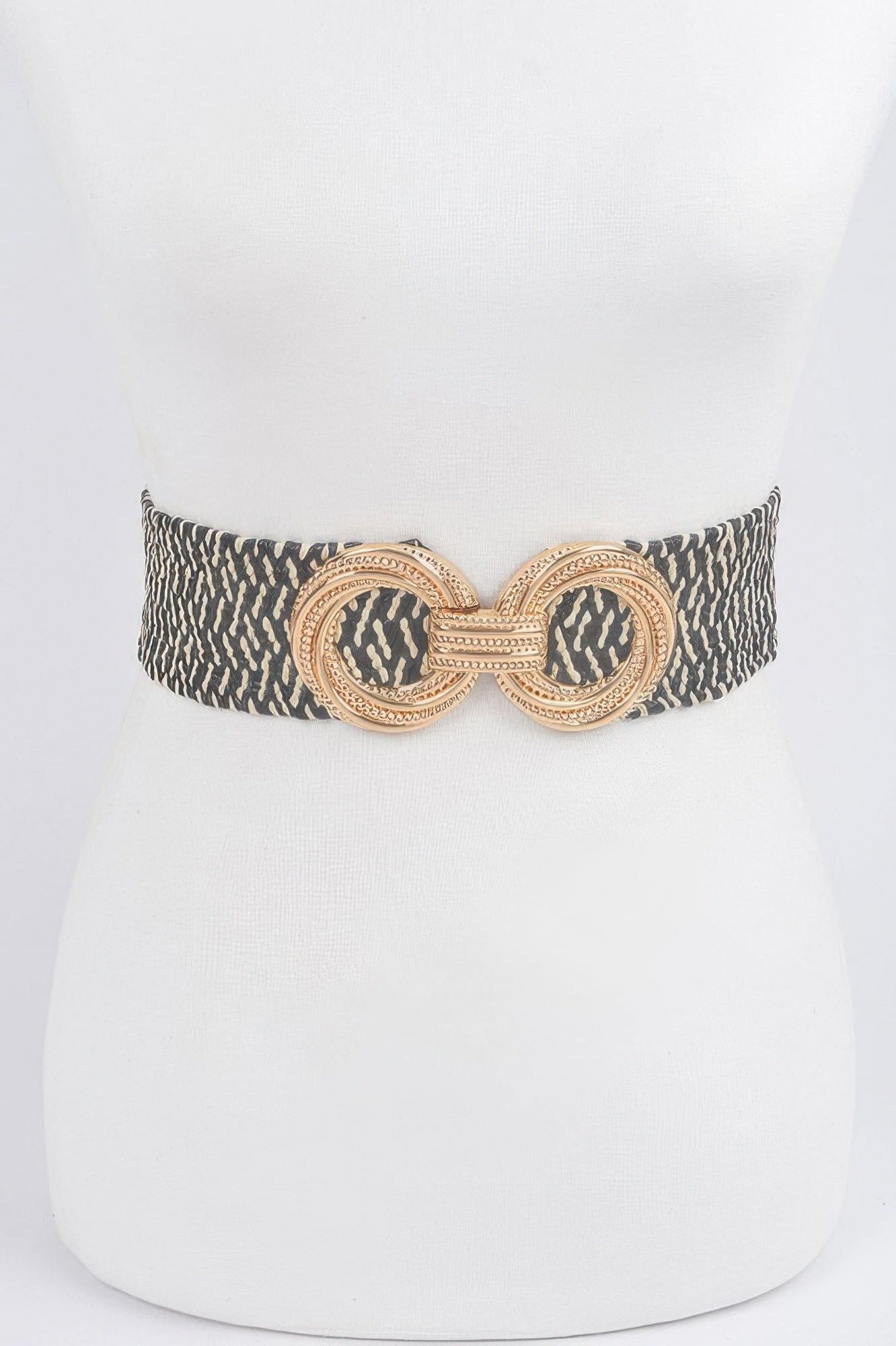 Dark patterned stretch waist belt with ornate round metal buckle and linked center design