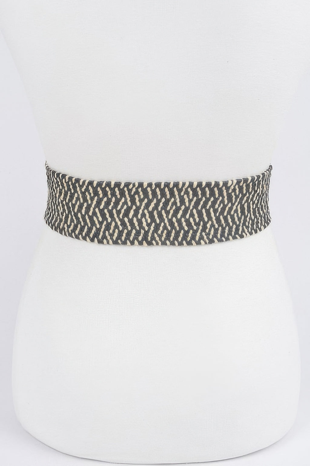 Dark patterned stretch waist belt band with textured woven fabric, buckle not visible