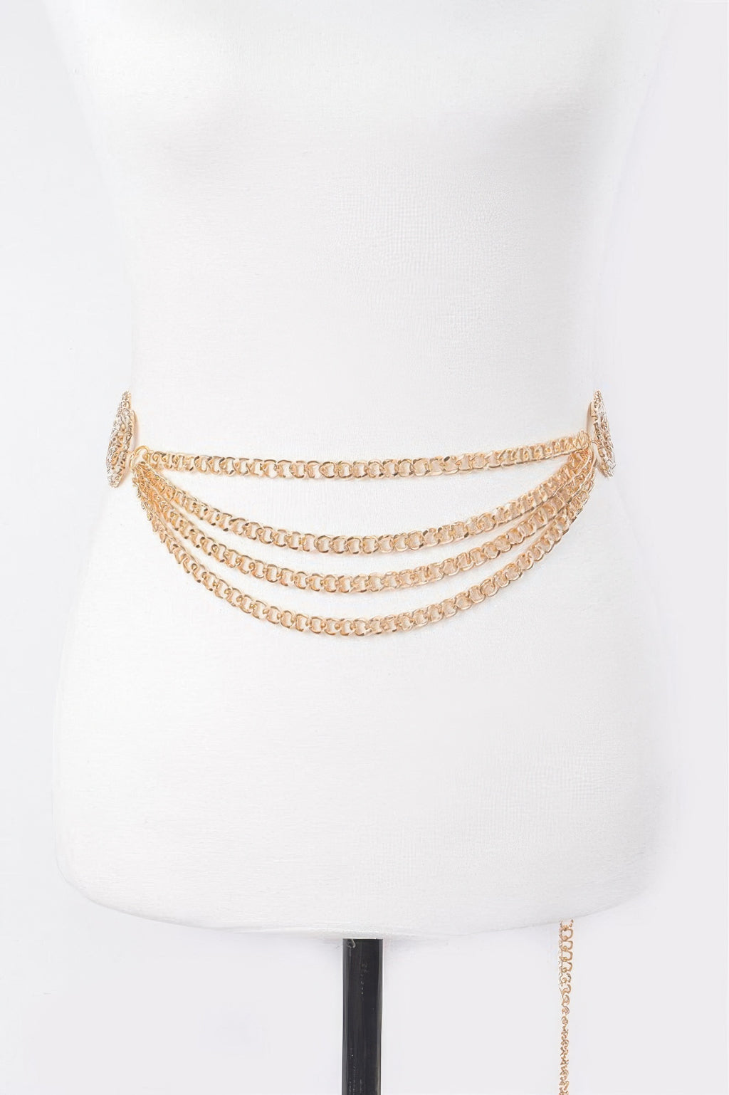 Gold layered chain belt draped across mannequin waist with round clasp charm