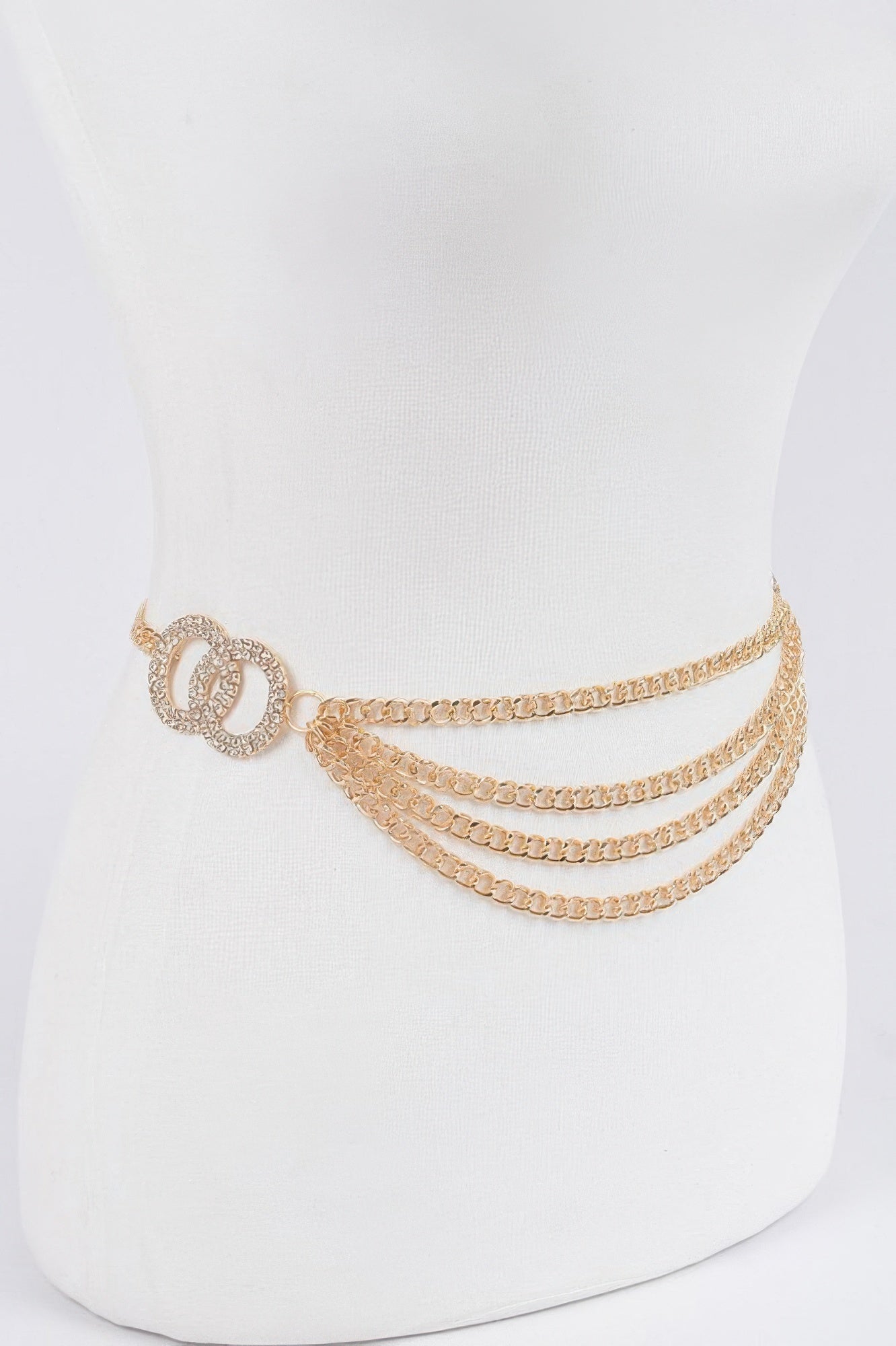 Gold layered chain belt on mannequin with circle buckle and three-tier chain drape