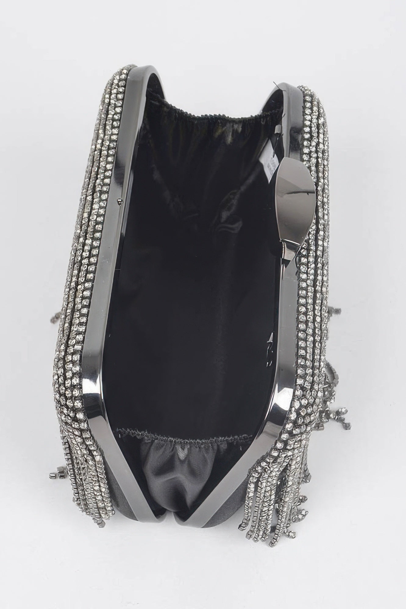 Rhinestone fringe hard clutch interior view, black lining with silver rhinestone trim