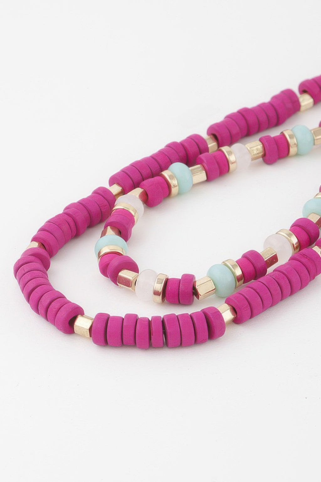Close-up: layered disk necklace in fuchsia with ivory, pale blue beads and gold rings