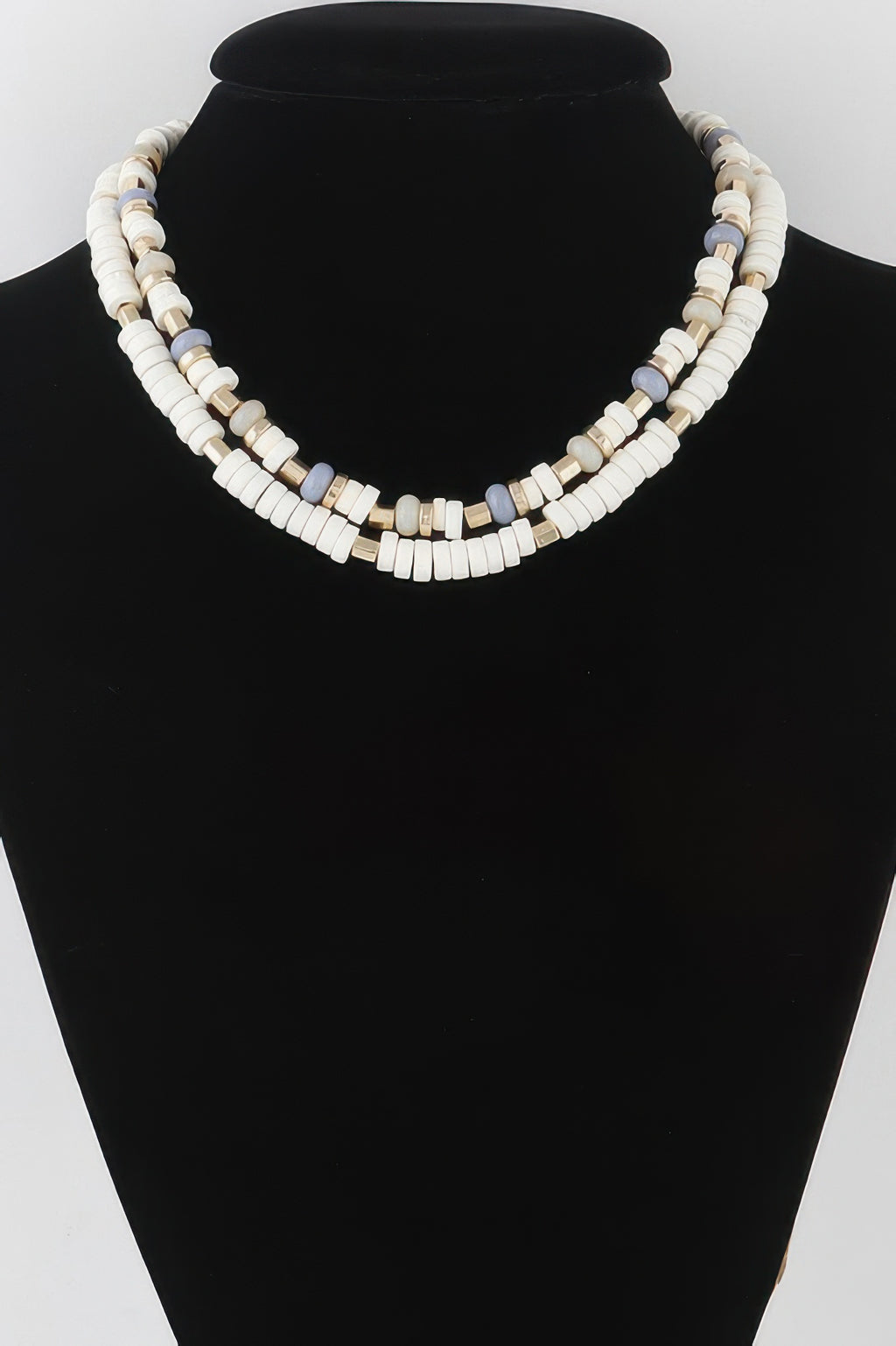 Layered disk necklace in ivory beads with light blue and gold spacer accents