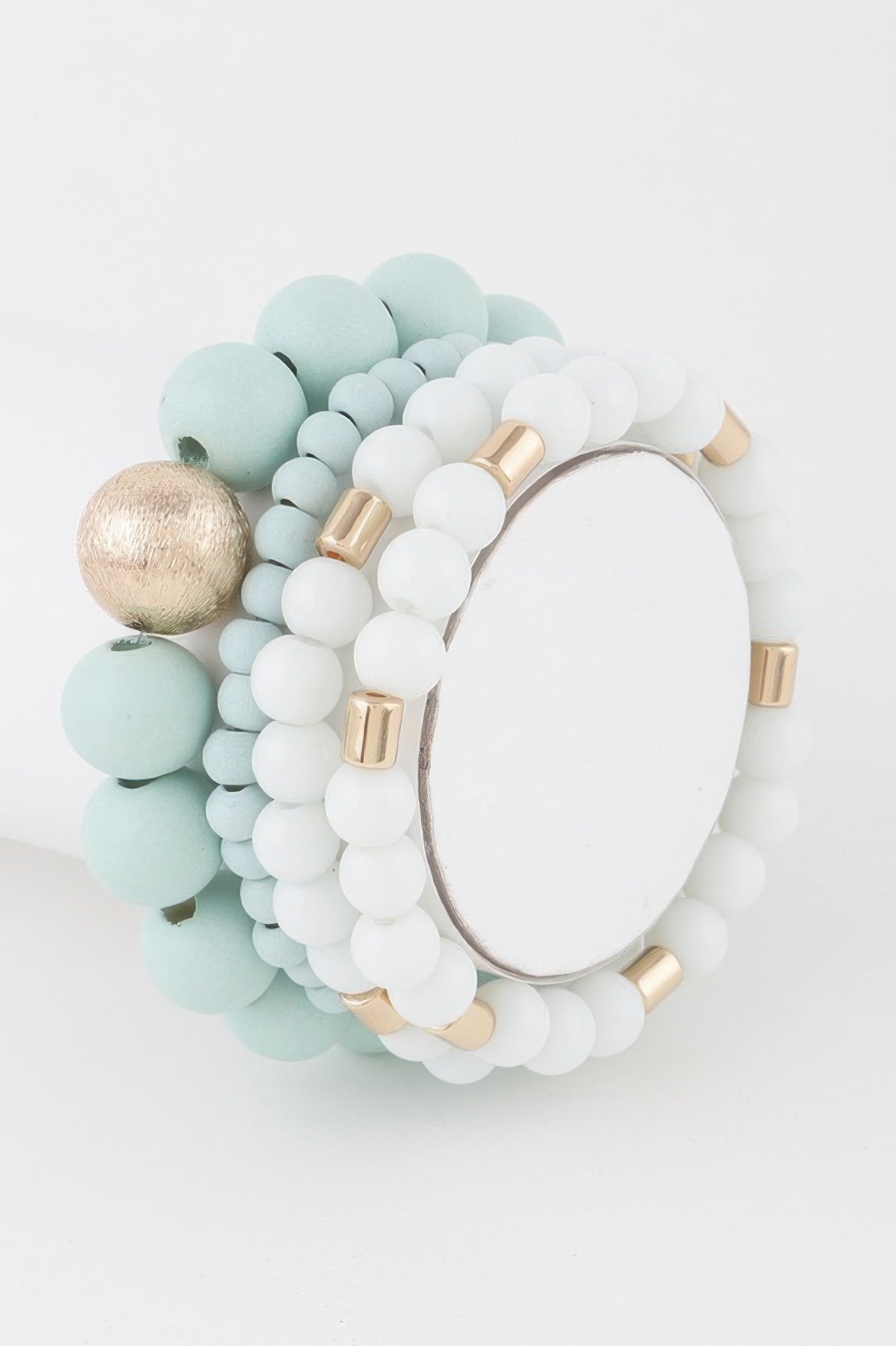 Mint and white beaded bracelet with gold-tone bar accents and bangle style