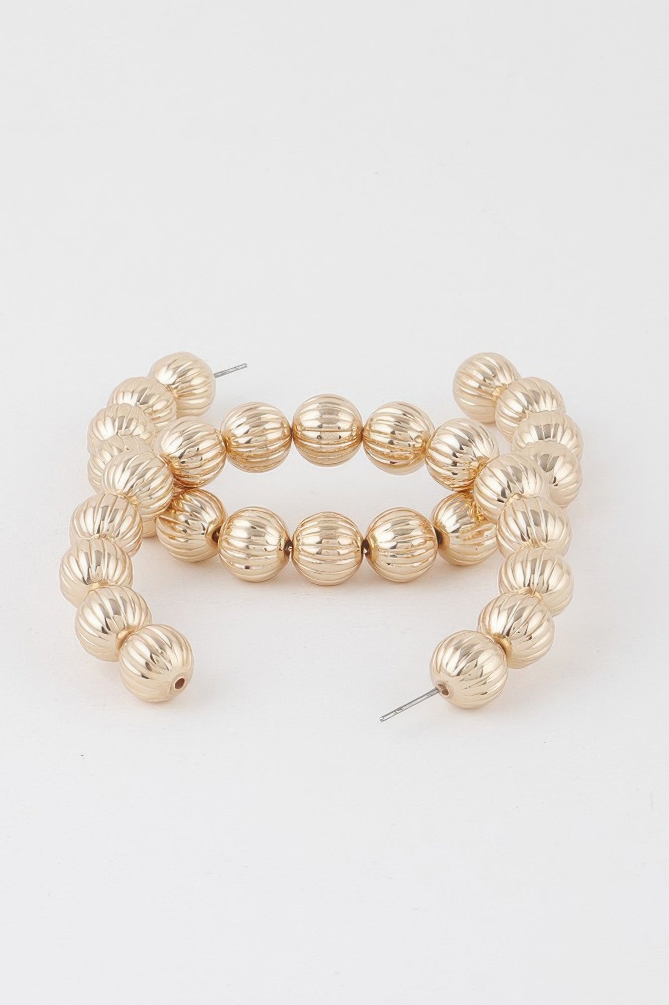 Round gold-tone beaded hoop earrings, textured bead rows around the hoop