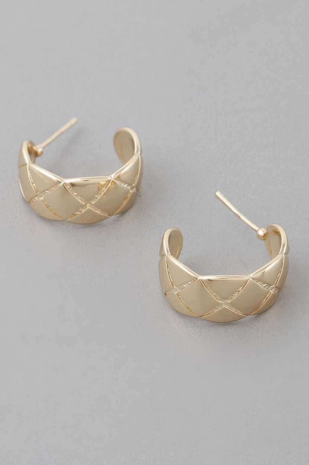 Gold diamond-cut hoop earrings with triangular grid detailing and hinged post backs