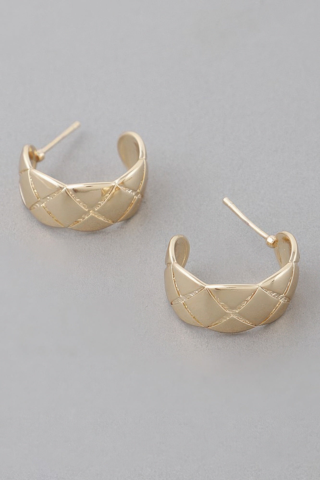 Gold diamond-cut hoop earrings with triangular grid detailing and hinged post backs