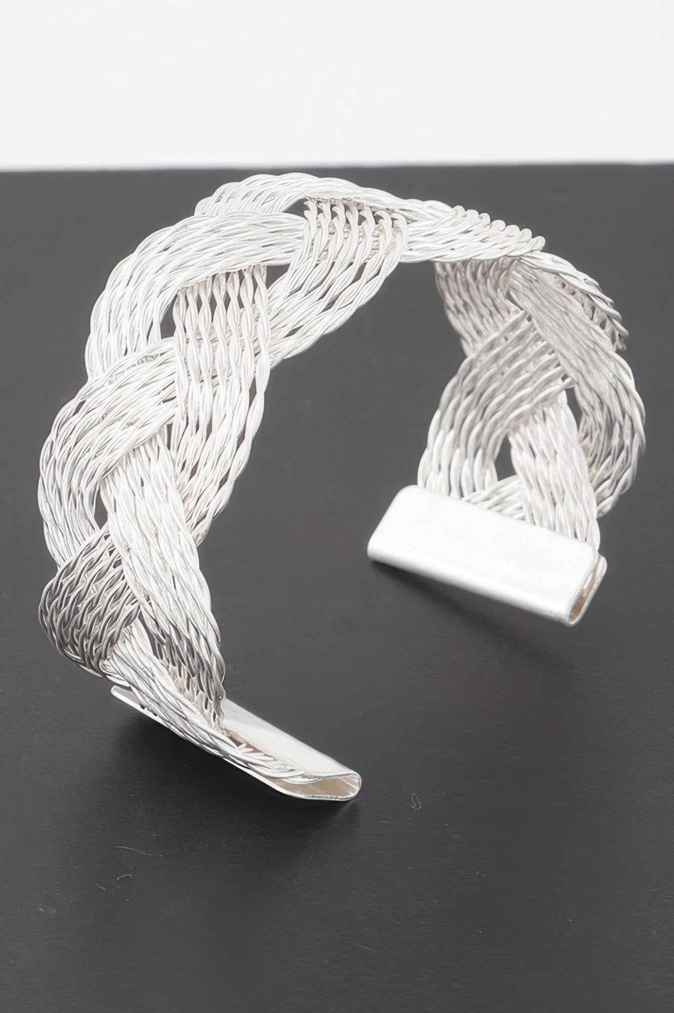 Twisted braid open cuff bracelet in silver, woven cable design with hinged cuff