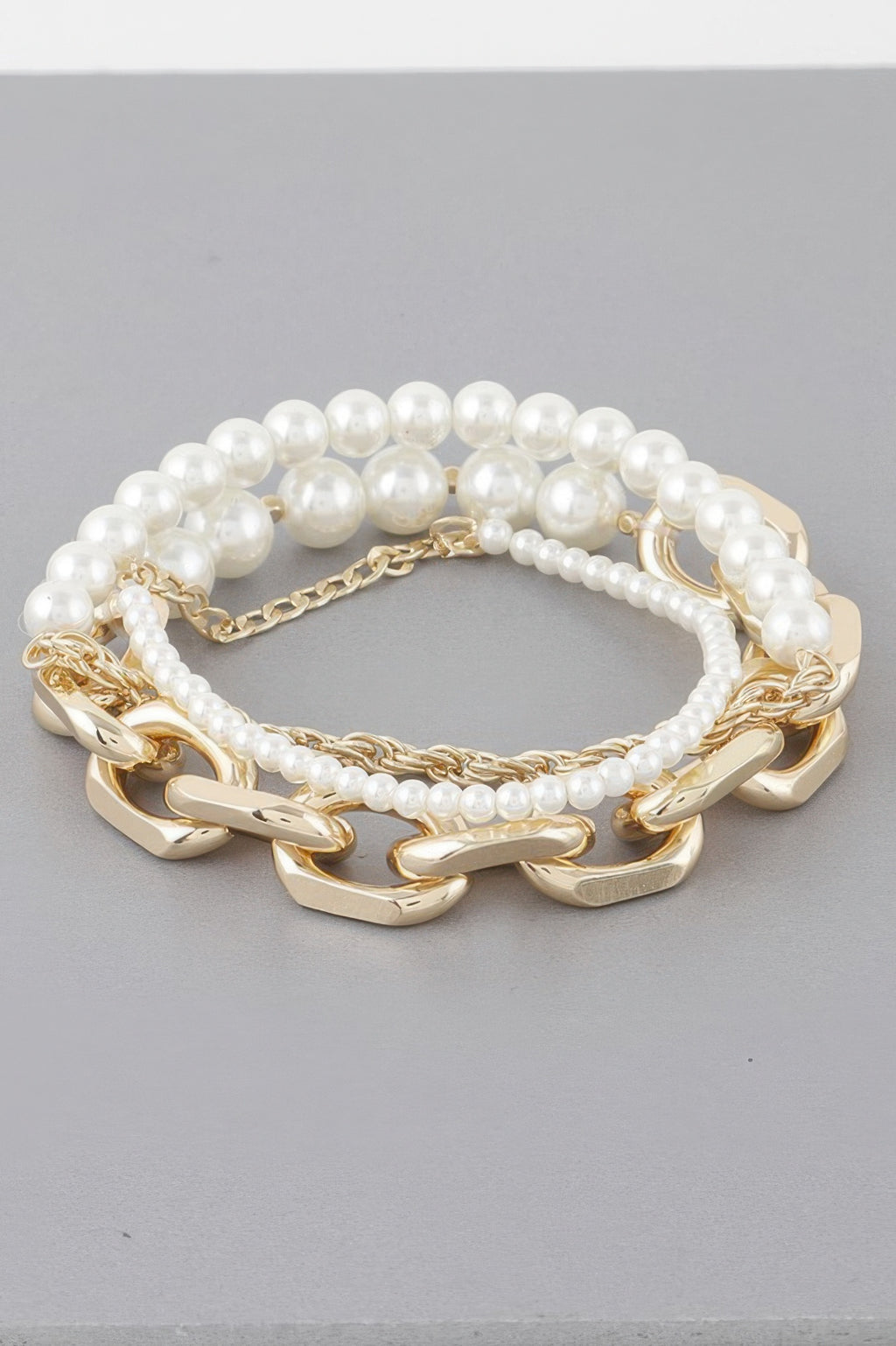 Multi Pearl Chain Bracelet: white pearl strands with gold-tone chunky link accents
