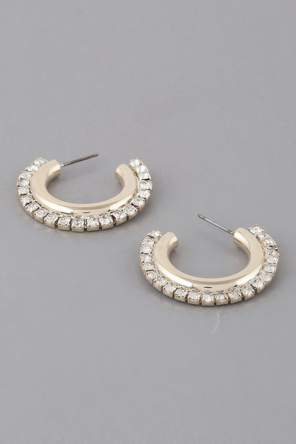 Gold hoop earrings with clear rhinestone lining, oval huggie style