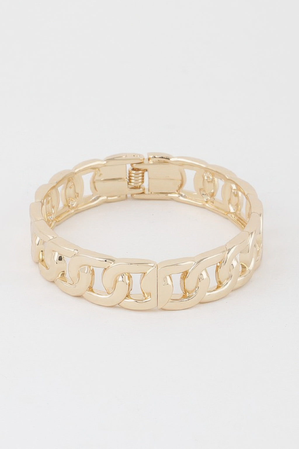 Gold curb chain cuff bracelet, hinge clasp centered on underside