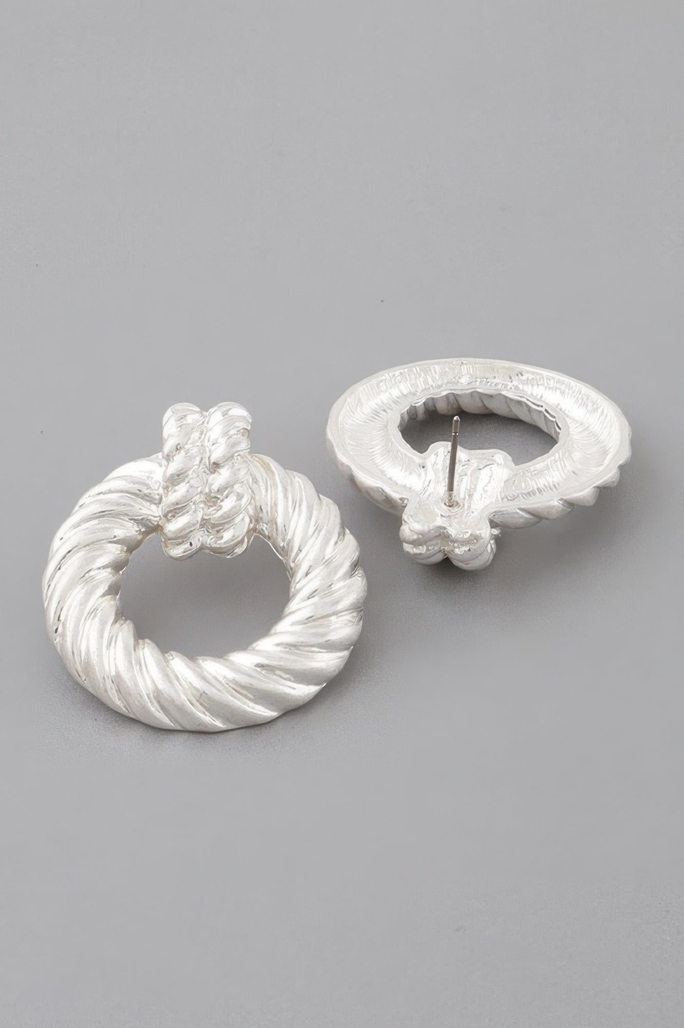 Silver twisted disk drop earrings with embossed rope-like texture