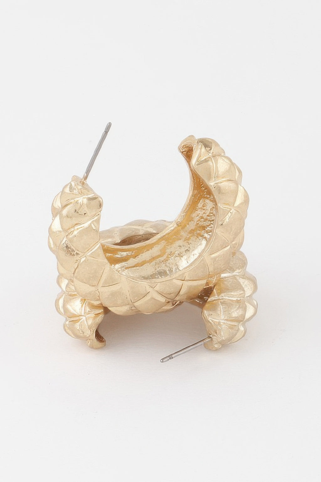 Quilted gold hoop earrings, side view showing clasp posts and glossy texture