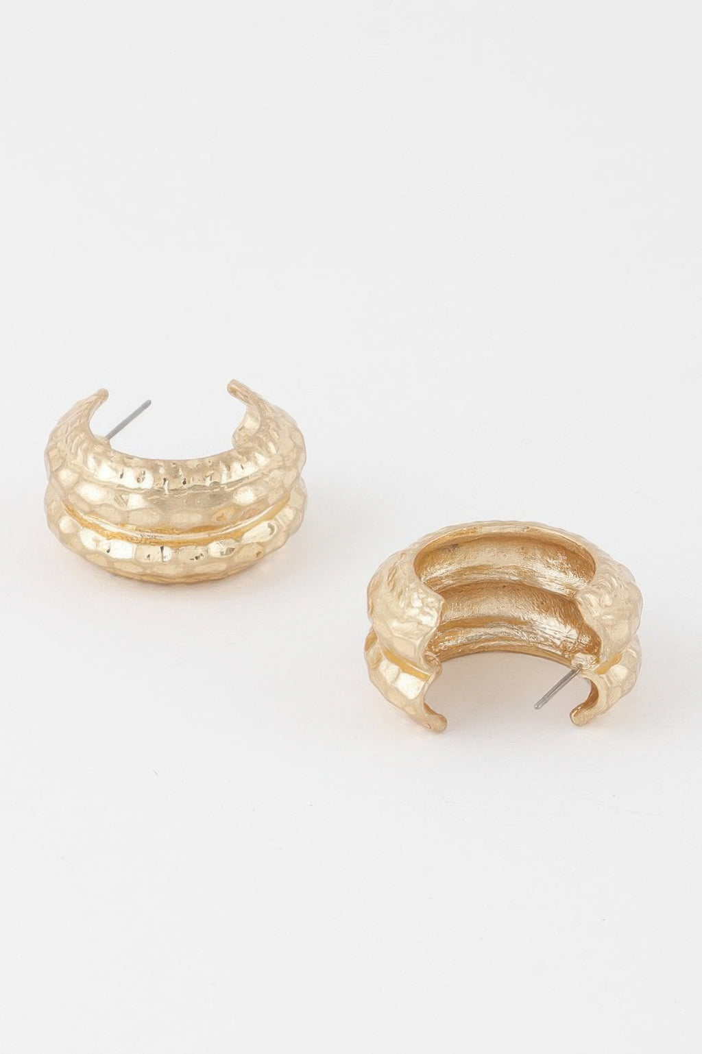 Gold double-hoop earrings with hammered texture and visible ear posts, side view