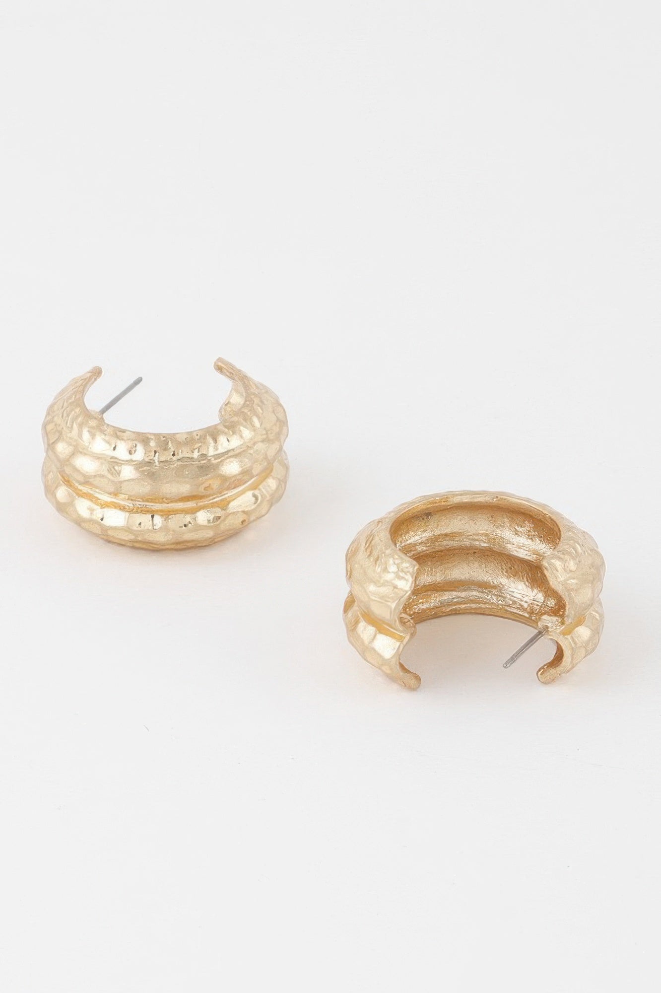 Gold double-hoop earrings with hammered texture and visible ear posts, side view