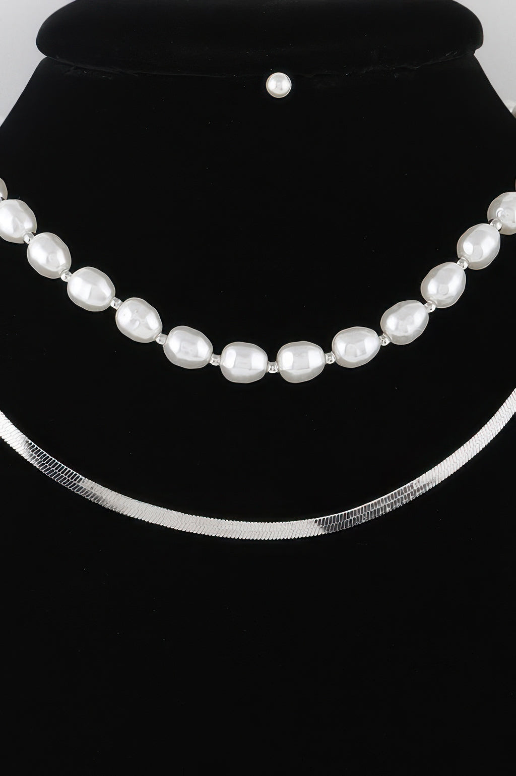 White pearl oval-bead necklace with silver-tone chain and spaced links