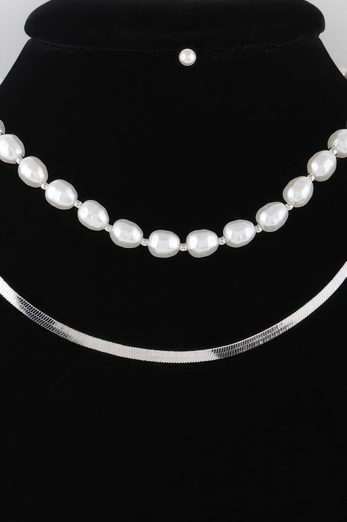 White pearl oval-bead necklace with silver-tone chain and spaced links