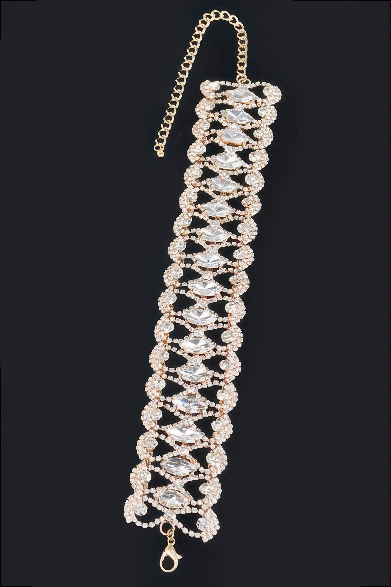 Silver rhinestone tennis necklace with large marquise stones and dangling clasp.