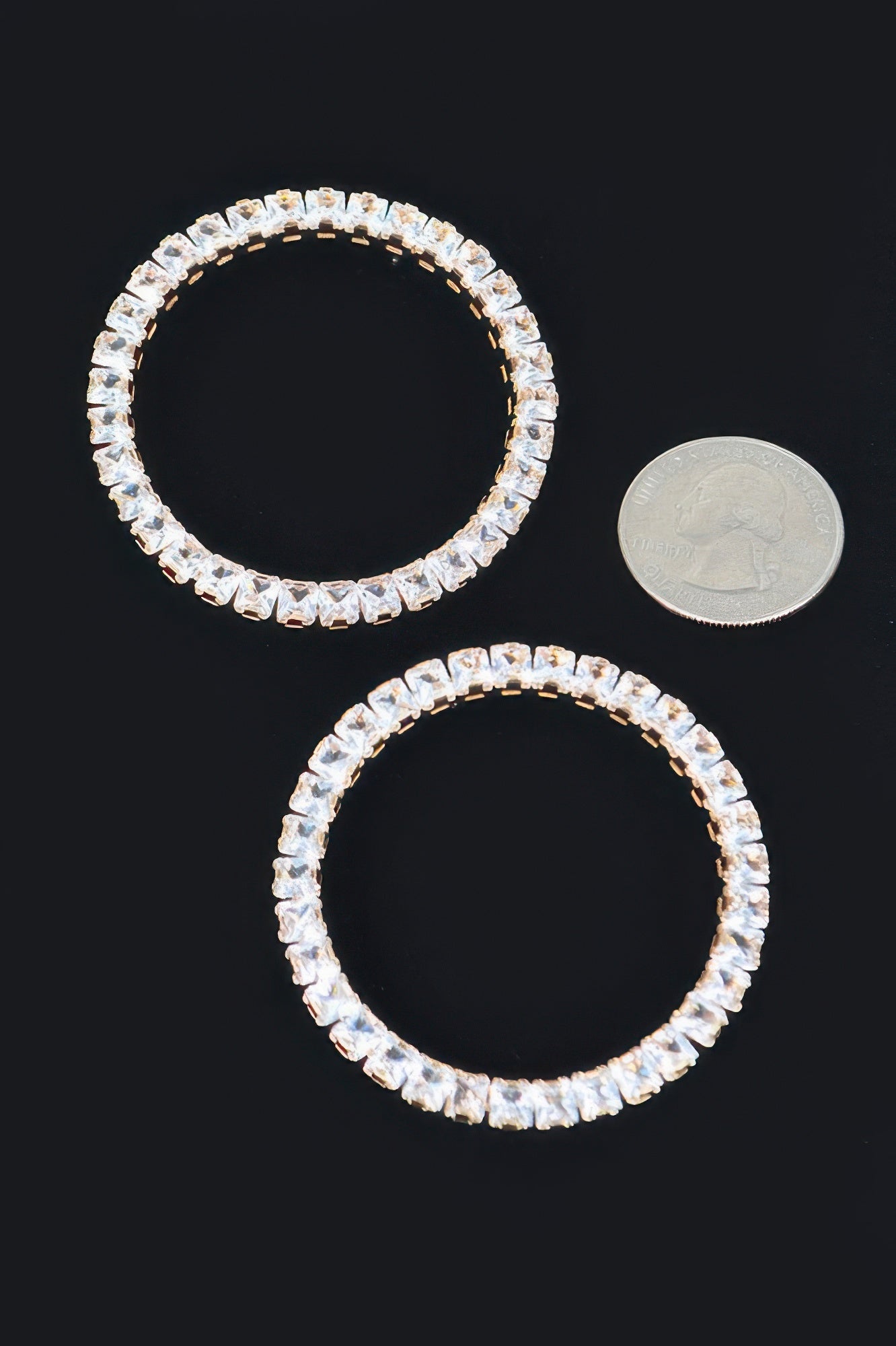 Pair of round rhinestone hoop earrings with clear stones and metal posts